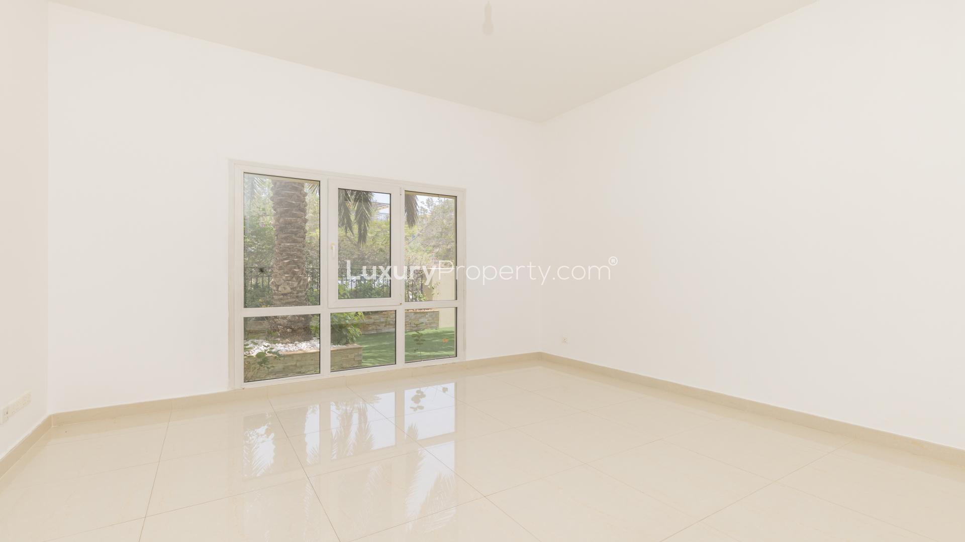 Upgraded 4-bedroom villa exterior in Meadows 9, Emirates Living, with garage and greenery