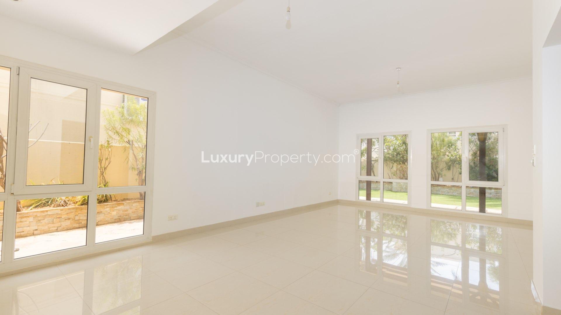 Upgraded villa entrance and staircase in Meadows 9, featuring sleek tiled flooring