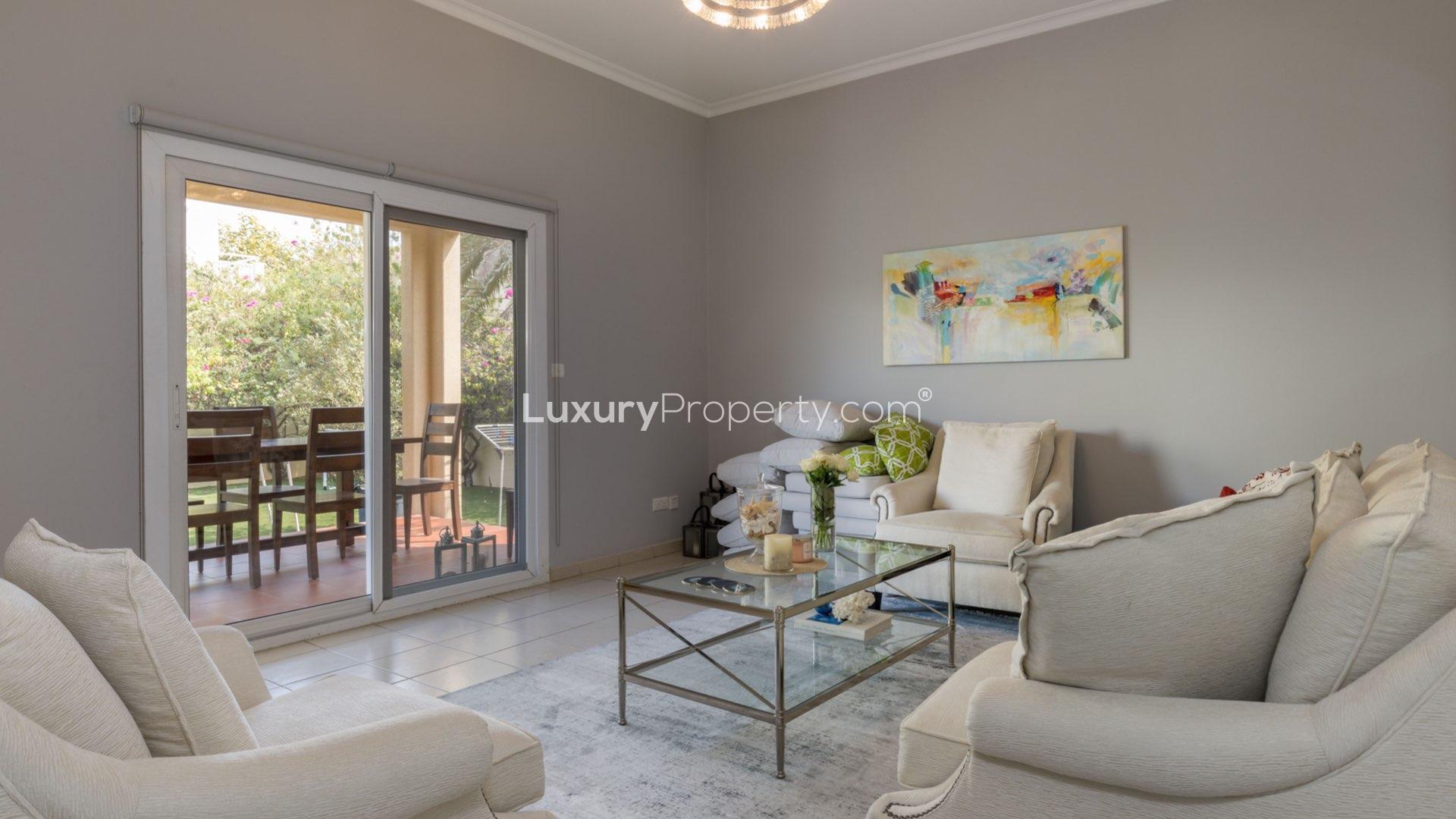 Bright living room in Meadows 1 villa with modern decor and garden view