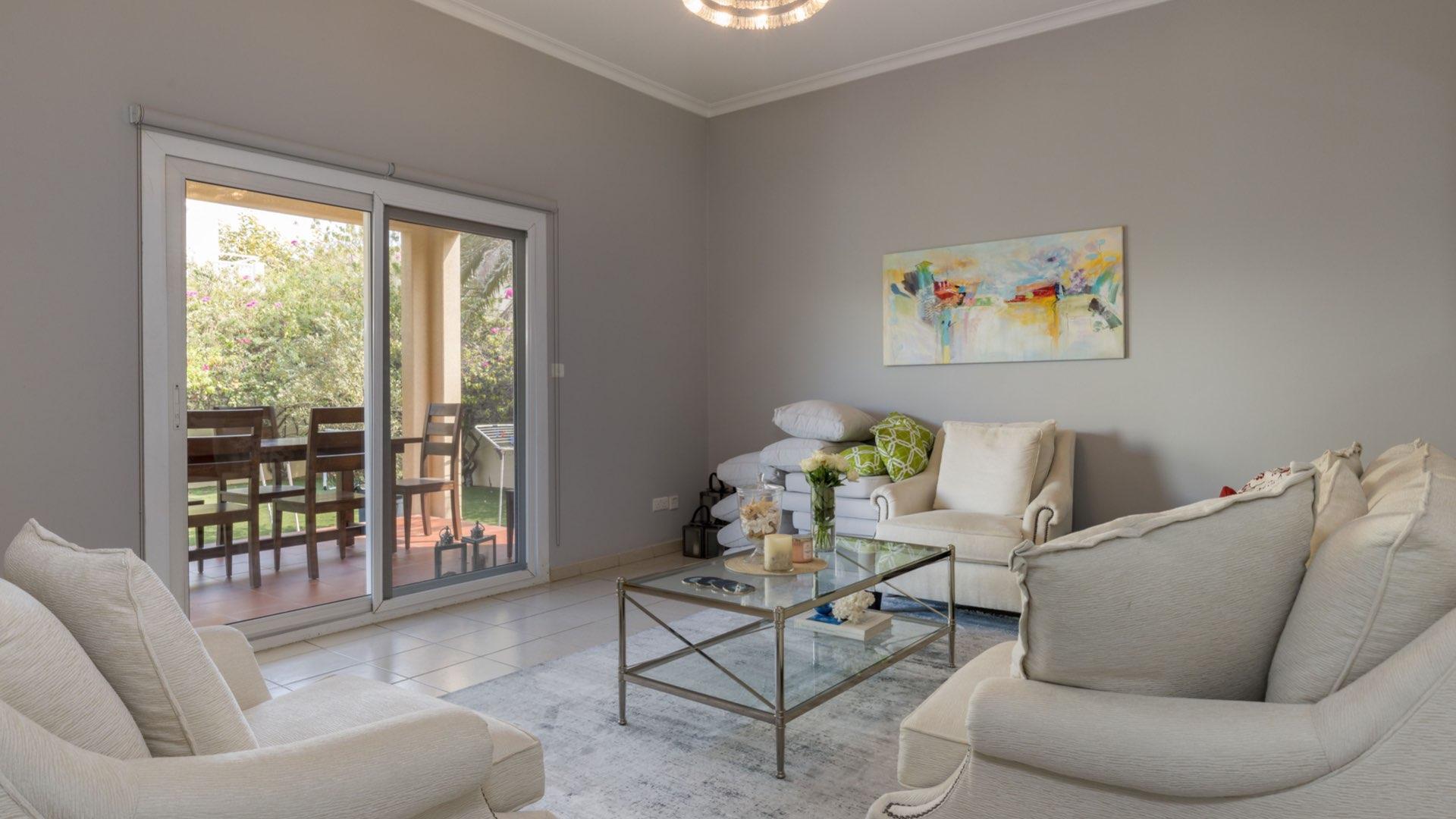 Bright living room in Meadows 1 villa with modern decor and garden view