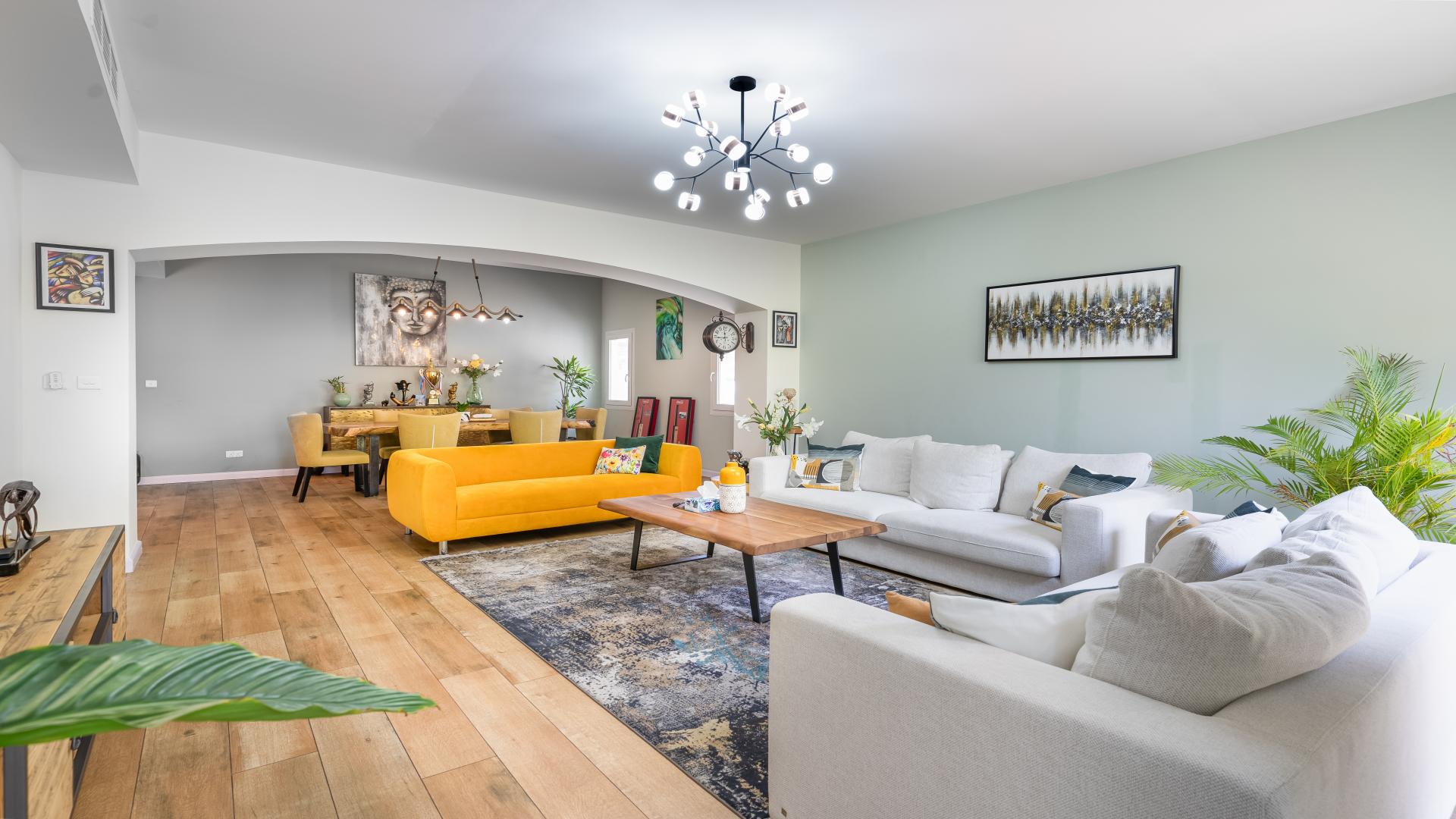 "Spacious living room in upgraded four-bedroom villa for sale in Meadows 9.",Bright living room with modern decor in Meadows 9 villa for sale, LP14578