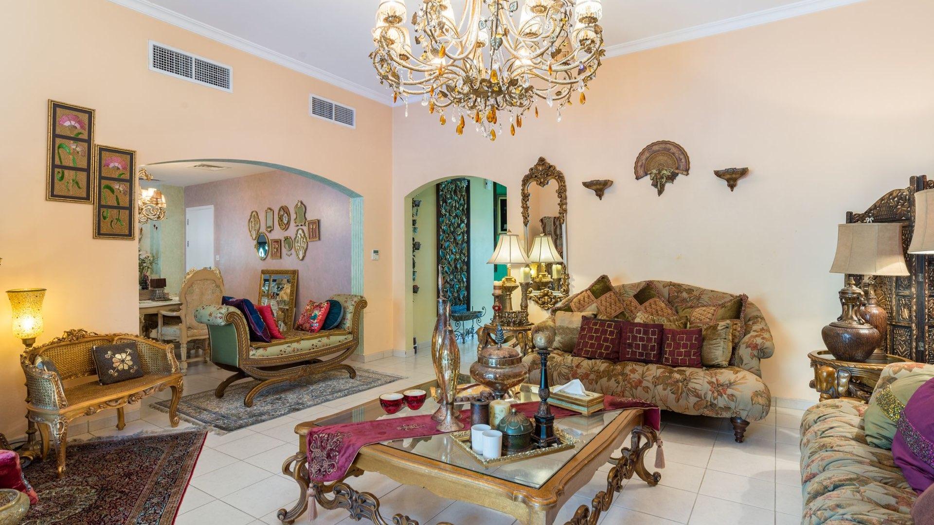 Elegant living room in Meadows villa with ornate decor and colorful accents