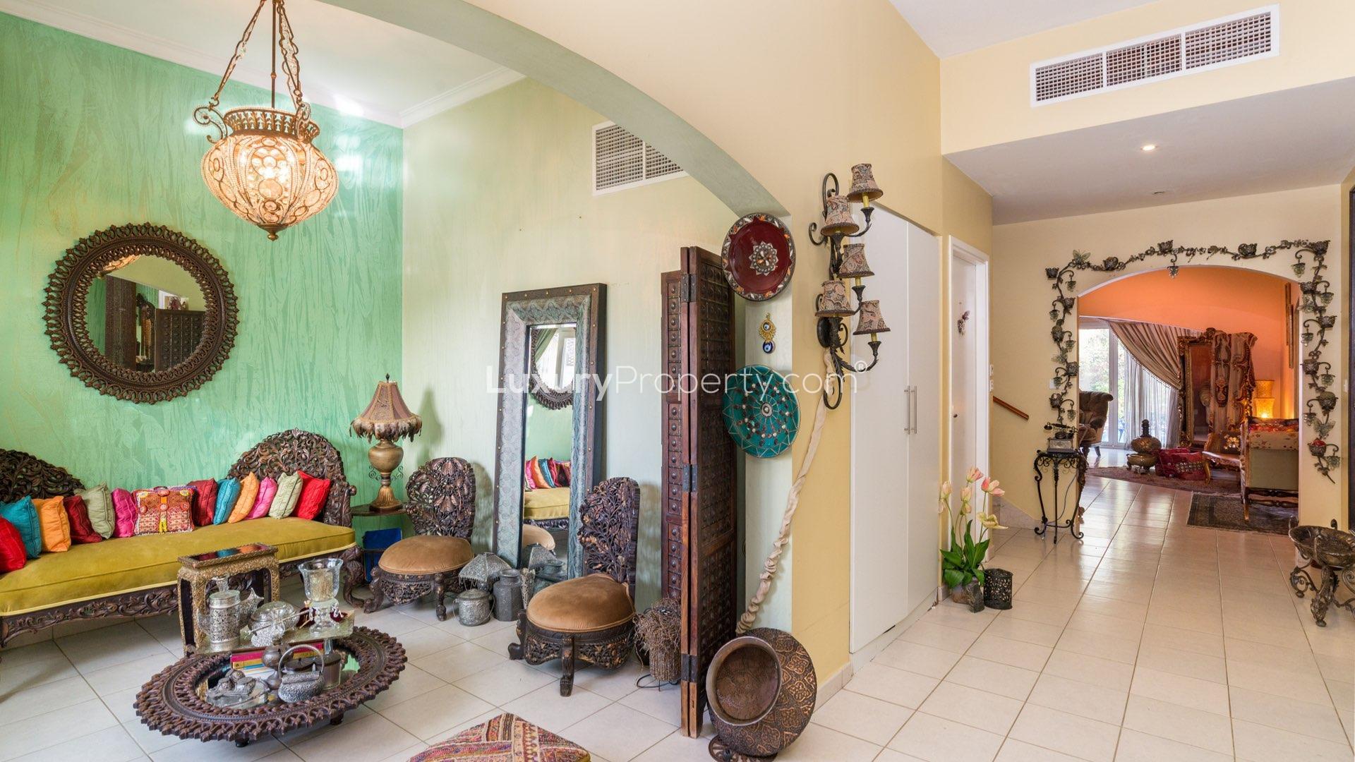 Luxurious living room in Meadows villa with elegant decor and pool view