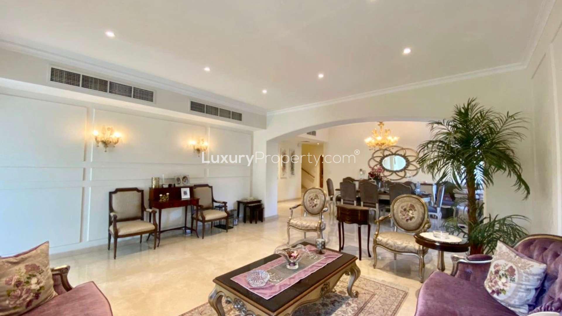 Beautiful villa exterior with patio, lush garden, and outdoor seating in Meadows 9