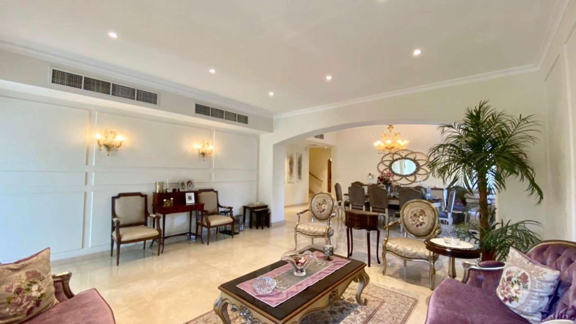 Beautiful villa exterior with patio, lush garden, and outdoor seating in Meadows 9