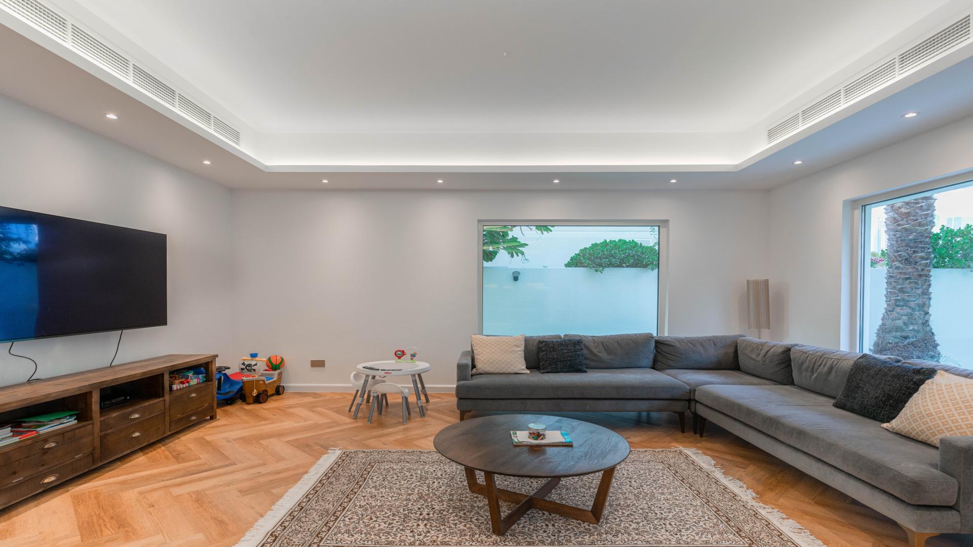 Living room in fully renovated villa, Meadows 2, featuring modern decor and garden view