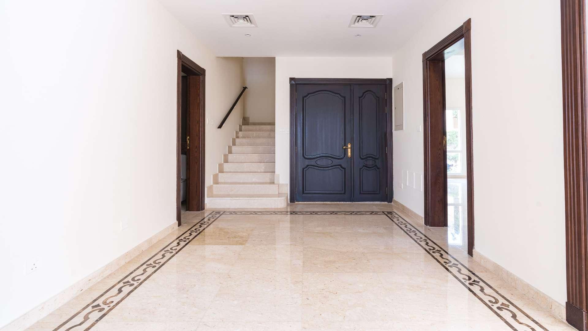 "Spacious villa interior with marble floors, large windows, overlooking landscaped garden and pool.","Elegant entrance with marble flooring in fully upgraded Meadows 2 villa for sale.","Spacious upgraded villa with landscaped garden and pool in Meadows 2, 4 bedrooms, for sale.",Luxurious upgraded kitchen in Meadows 2 villa, featuring modern cabinetry and appliances