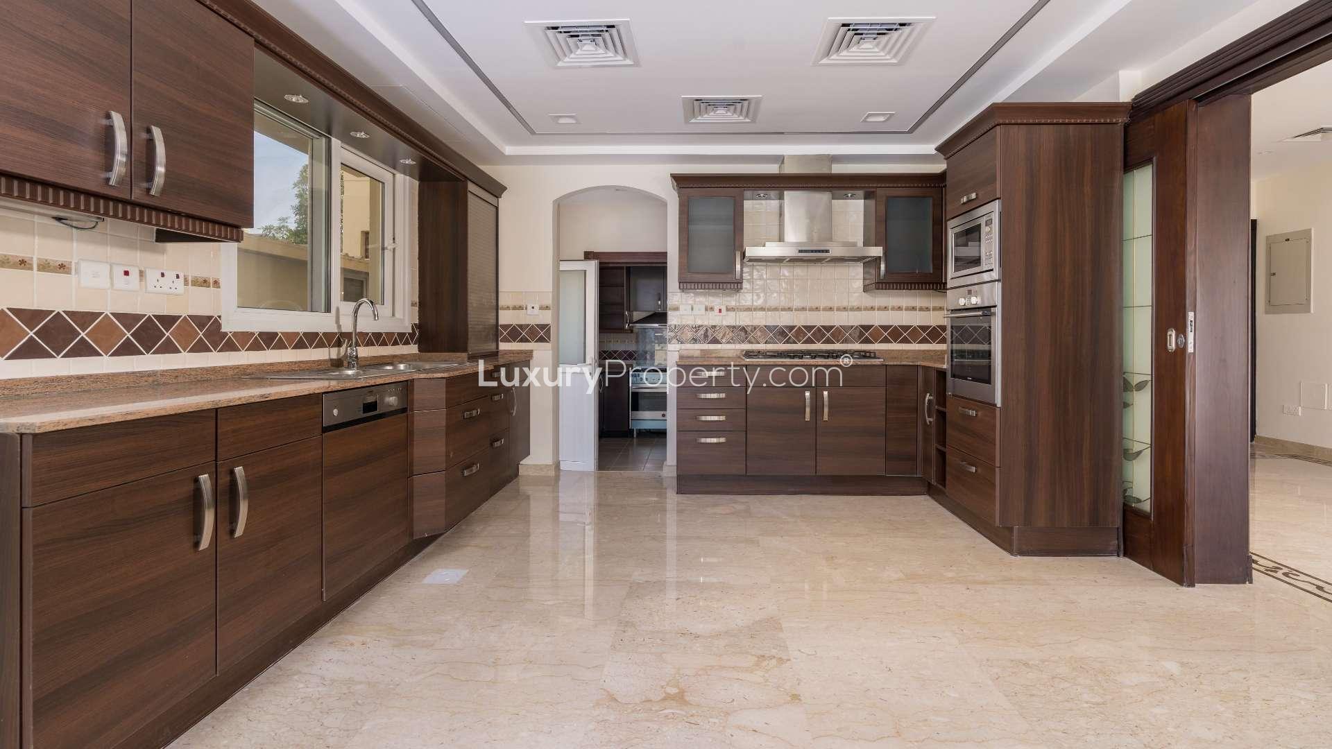 "Bright room in fully upgraded Meadows 2 villa with large windows and marble flooring.",Luxurious villa in Meadows 2 with landscaped garden, pool, and skyline view for sale