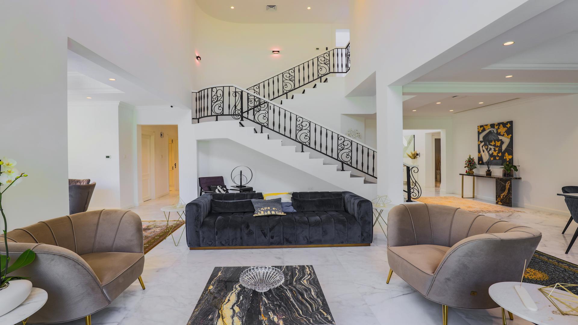 Elegant Mediterranean-style villa exterior with lush greenery in Jumeirah Islands, for sale