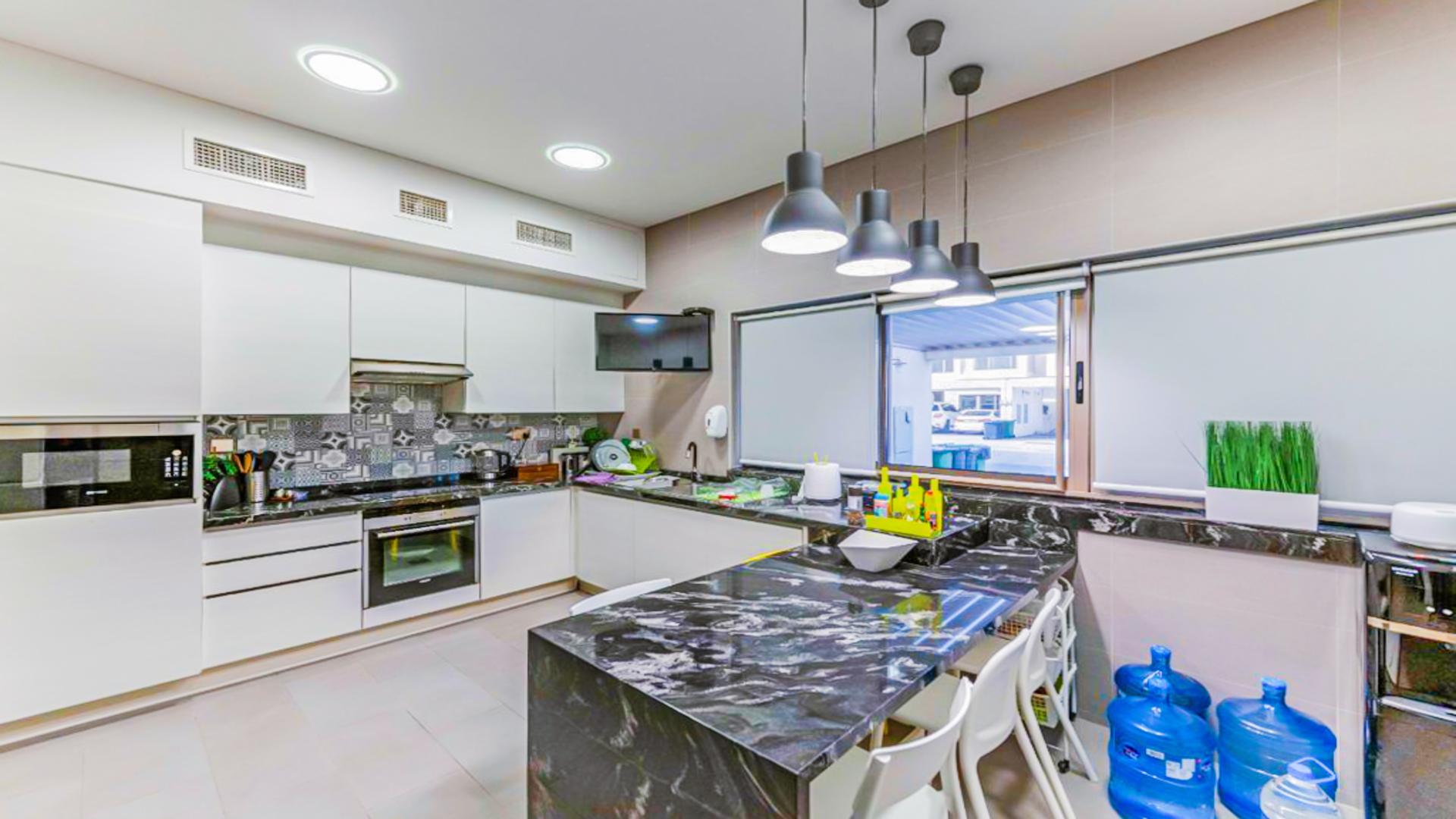 Modern living and dining area in Meydan townhouse for sale, featuring stylish decor