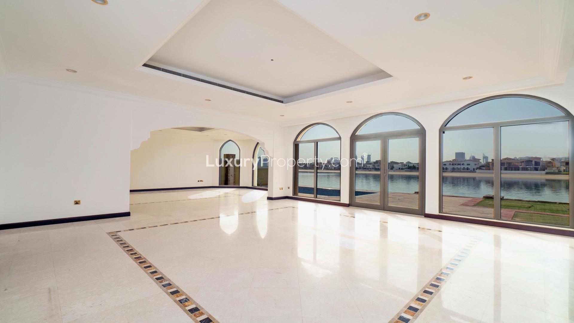 Bright living room in Palm Jumeirah villa with large windows and waterfront view