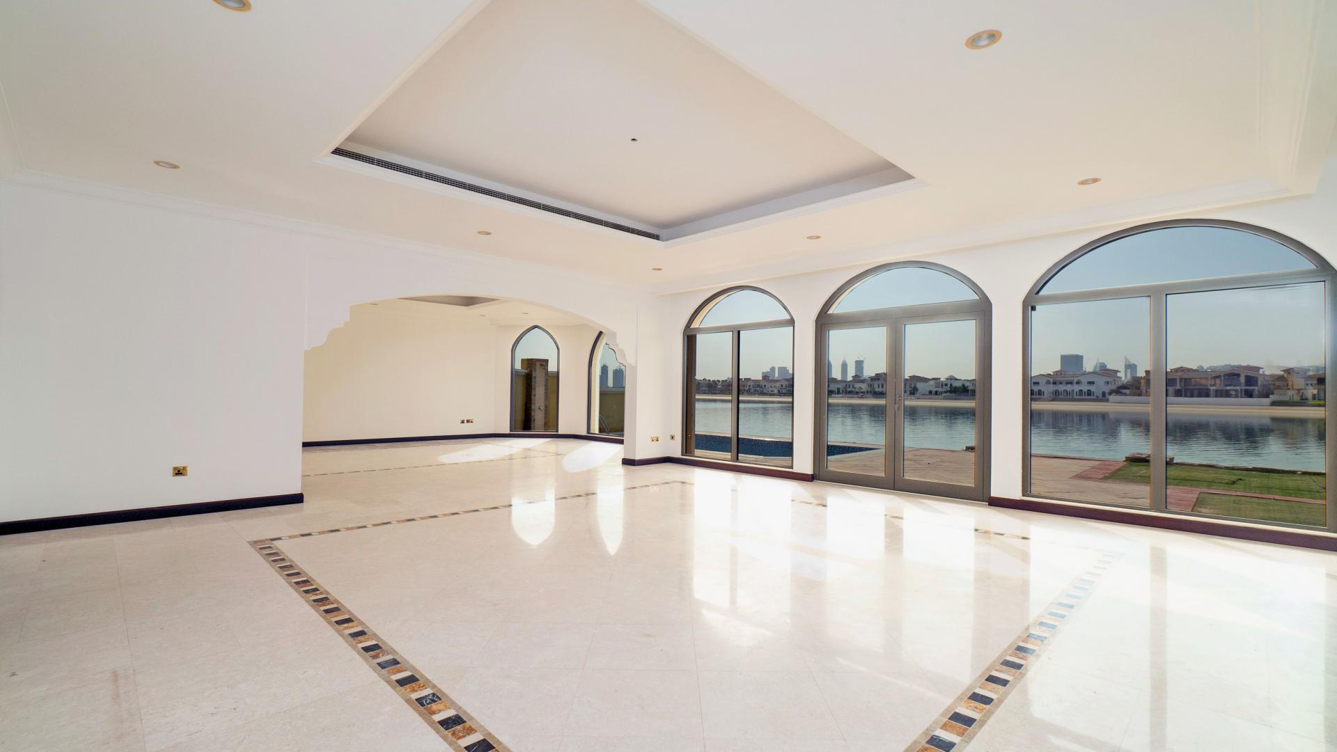 Bright living room in Palm Jumeirah villa with large windows and waterfront view