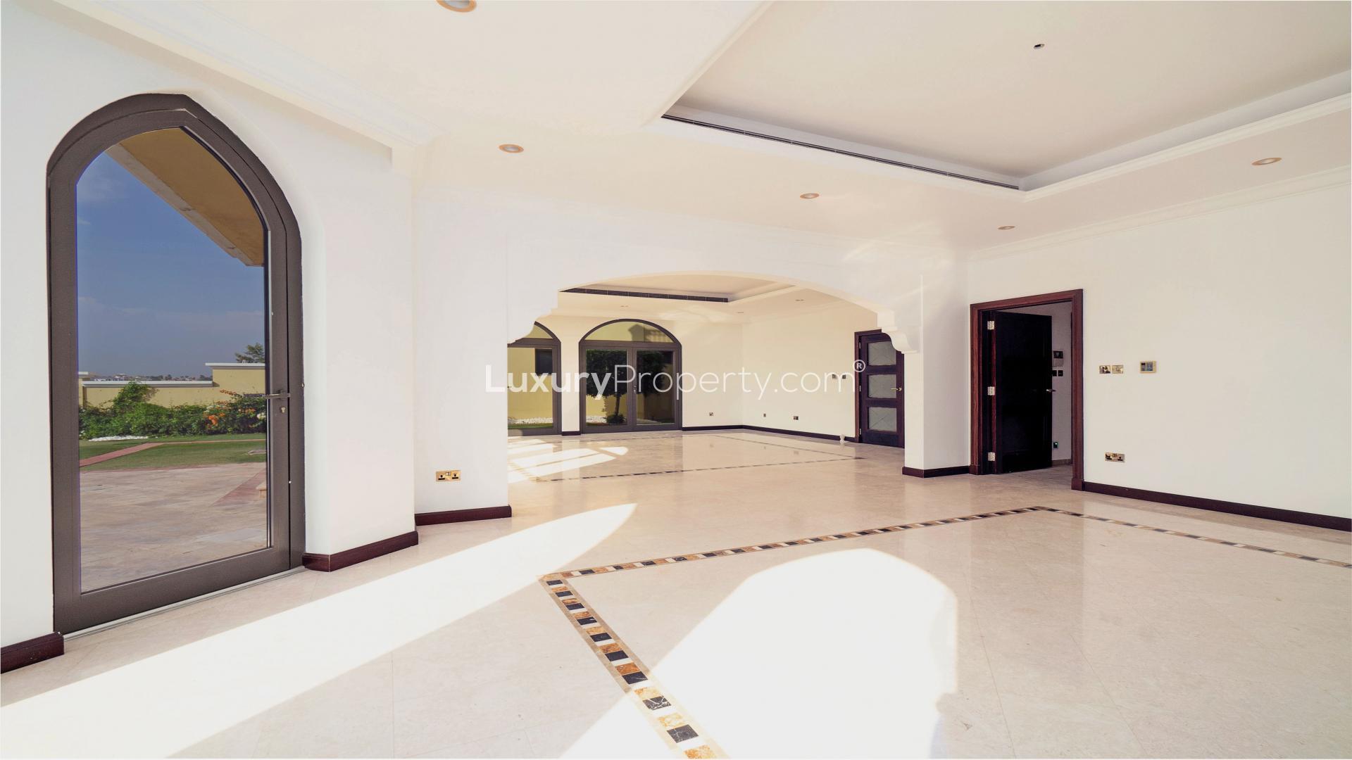 "Spacious villa living room with large windows overlooking Palm Jumeirah waterfront in Garden Homes.",Bright, spacious interior of upgraded Atrium Entry Garden Home, Palm Jumeirah villa for sale