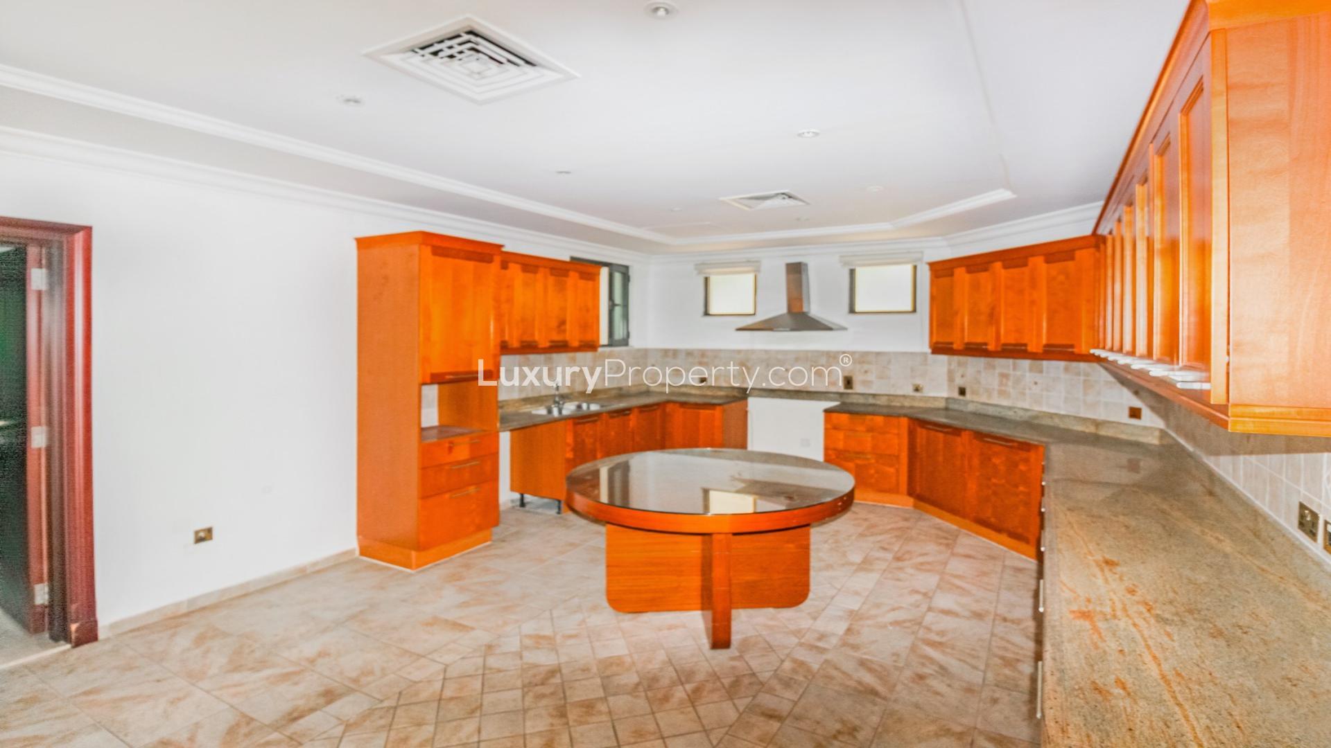 Spacious living area with large windows overlooking water, Palm Jumeirah villa for sale