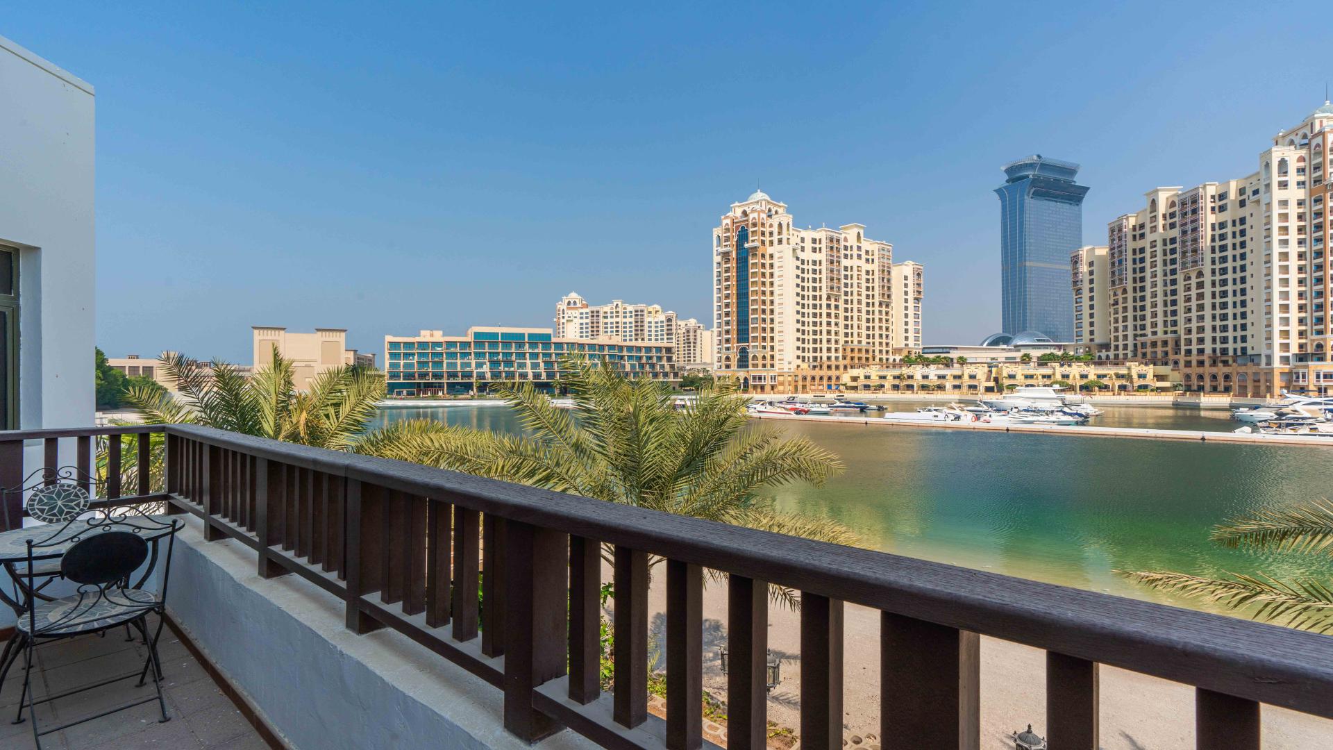 "Modern 4-bed villa exterior with pool in Palm Jumeirah's Garden Homes community.","Palm Jumeirah villa balcony view with waterfront and skyline, Garden Homes Frond P.",Palm Jumeirah Garden Homes villa with private pool and marina views for sale
