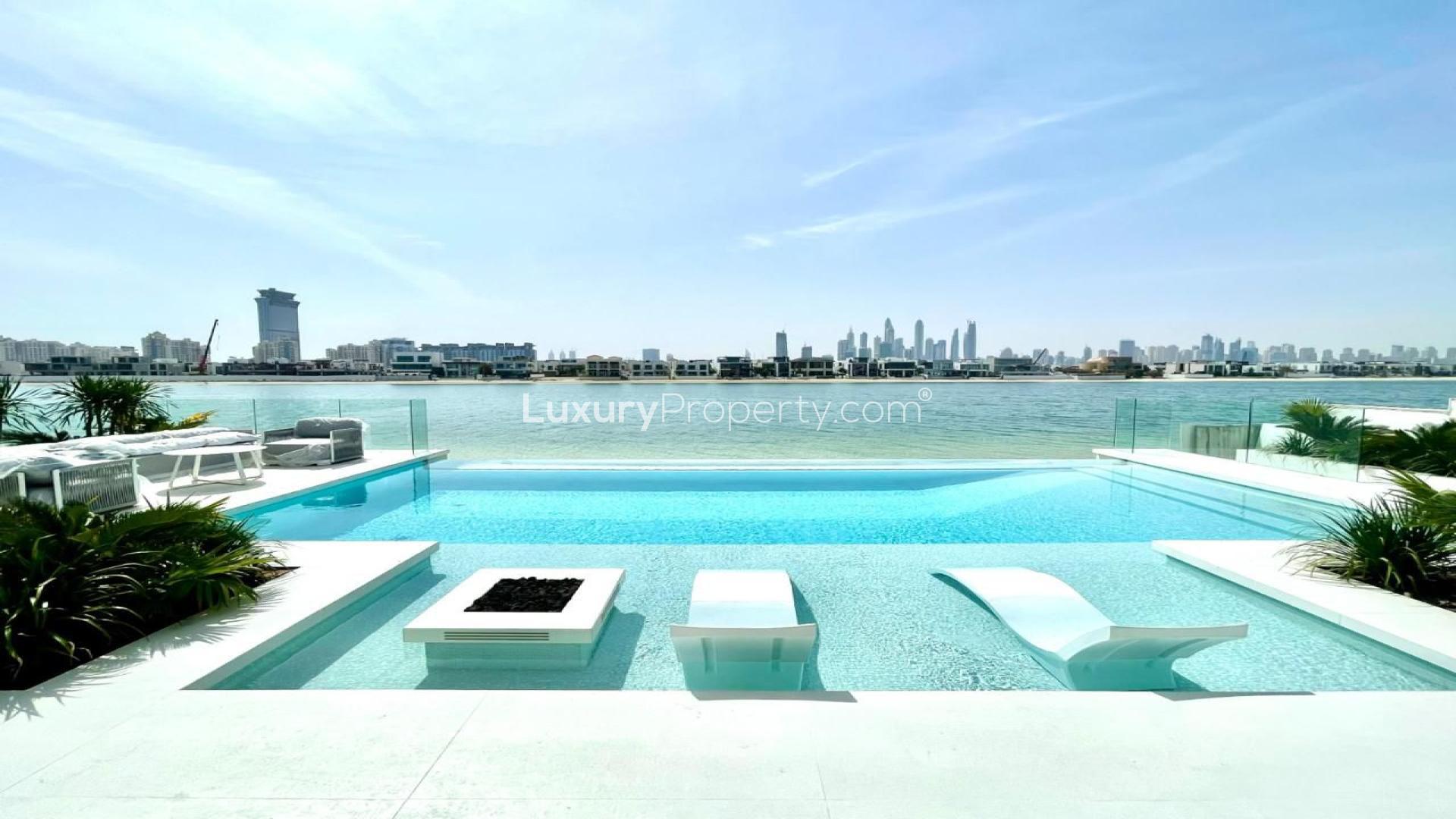 Luxurious open-plan living room with modern decor and stunning waterfront views in Palm Jumeirah villa
