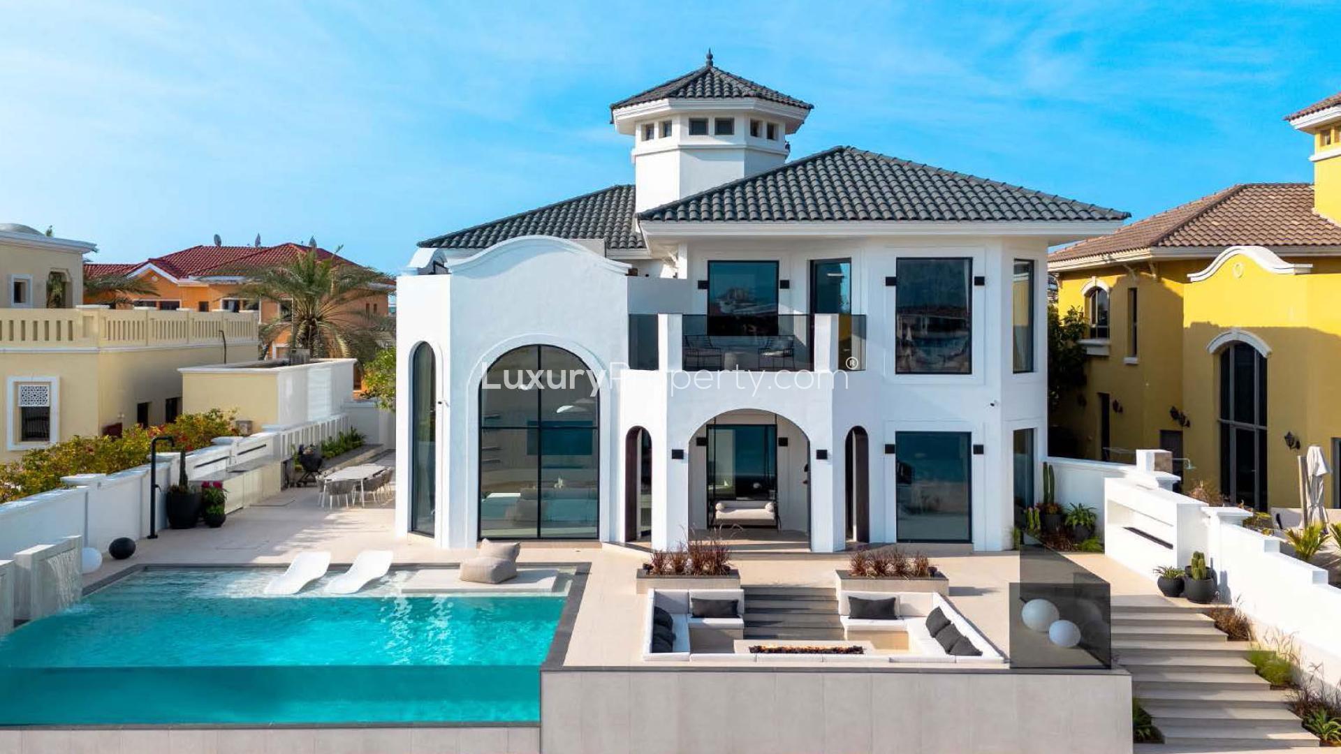 Spacious living room in Palm Jumeirah villa with large windows and elegant decor