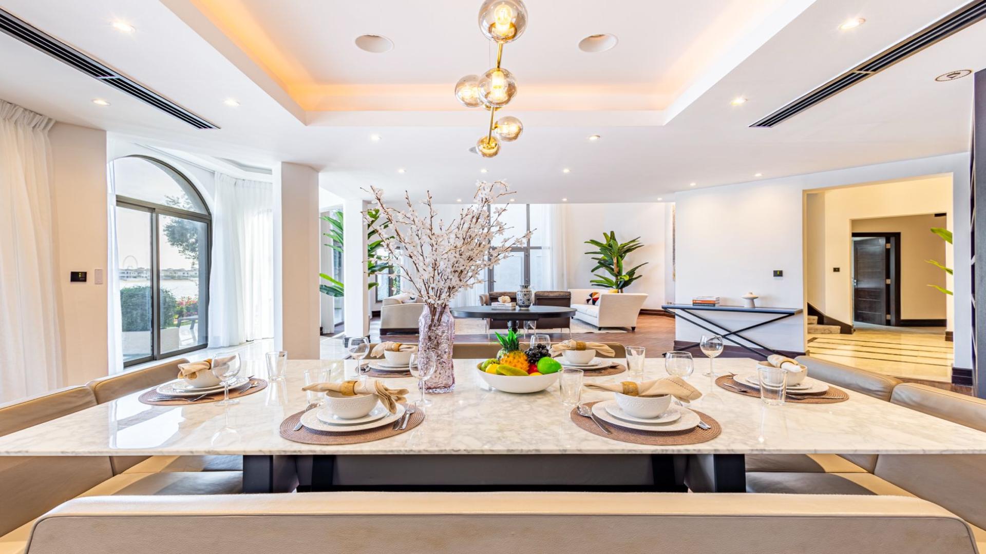 Luxurious living room in fully renovated Palm Jumeirah villa with large windows and elegant decor