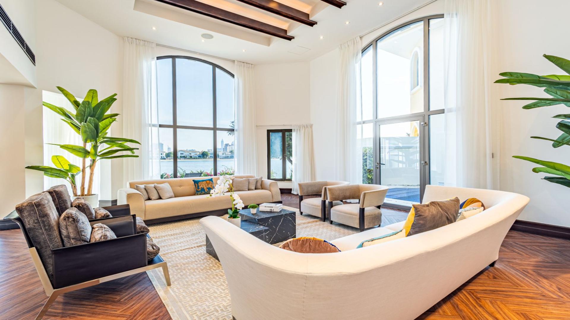 Luxurious living room in Central Rotunda Villa, Palm Jumeirah, with large windows and sea view