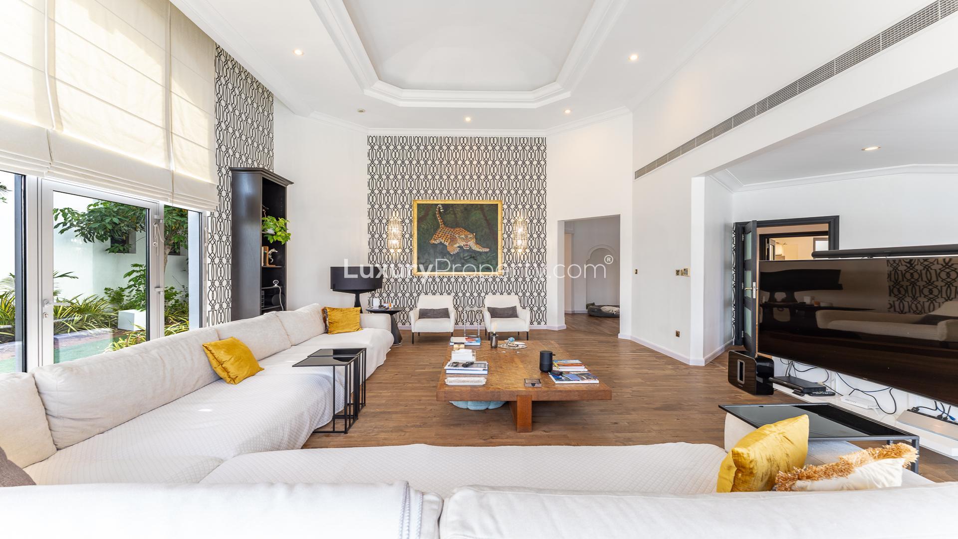 "Luxurious waterfront villa with pool and city views in Palm Jumeirah, Dubai.",Luxurious living room in 4-bedroom villa, Palm Jumeirah, featuring elegant decor and garden view