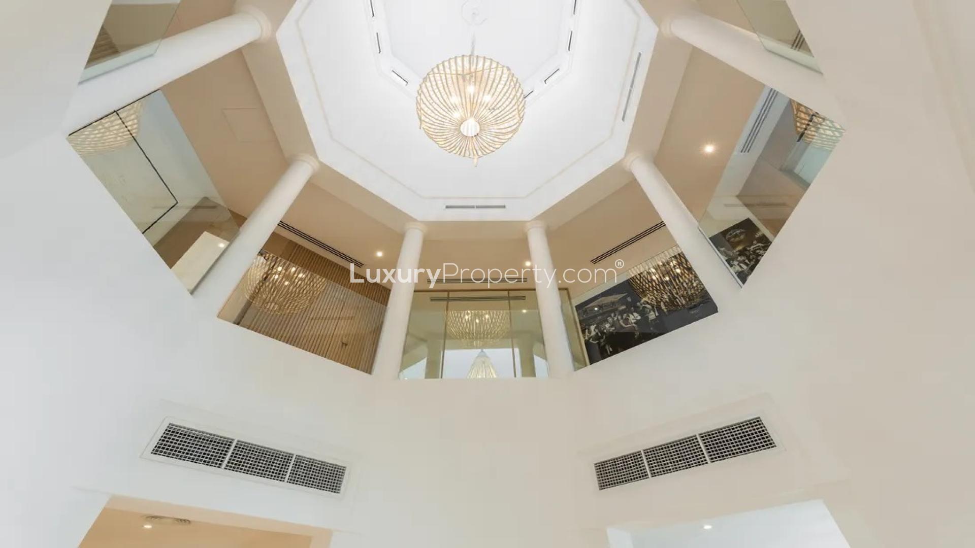 Modern kitchen in Palm Jumeirah Garden Homes villa, featuring sleek white cabinetry and appliances