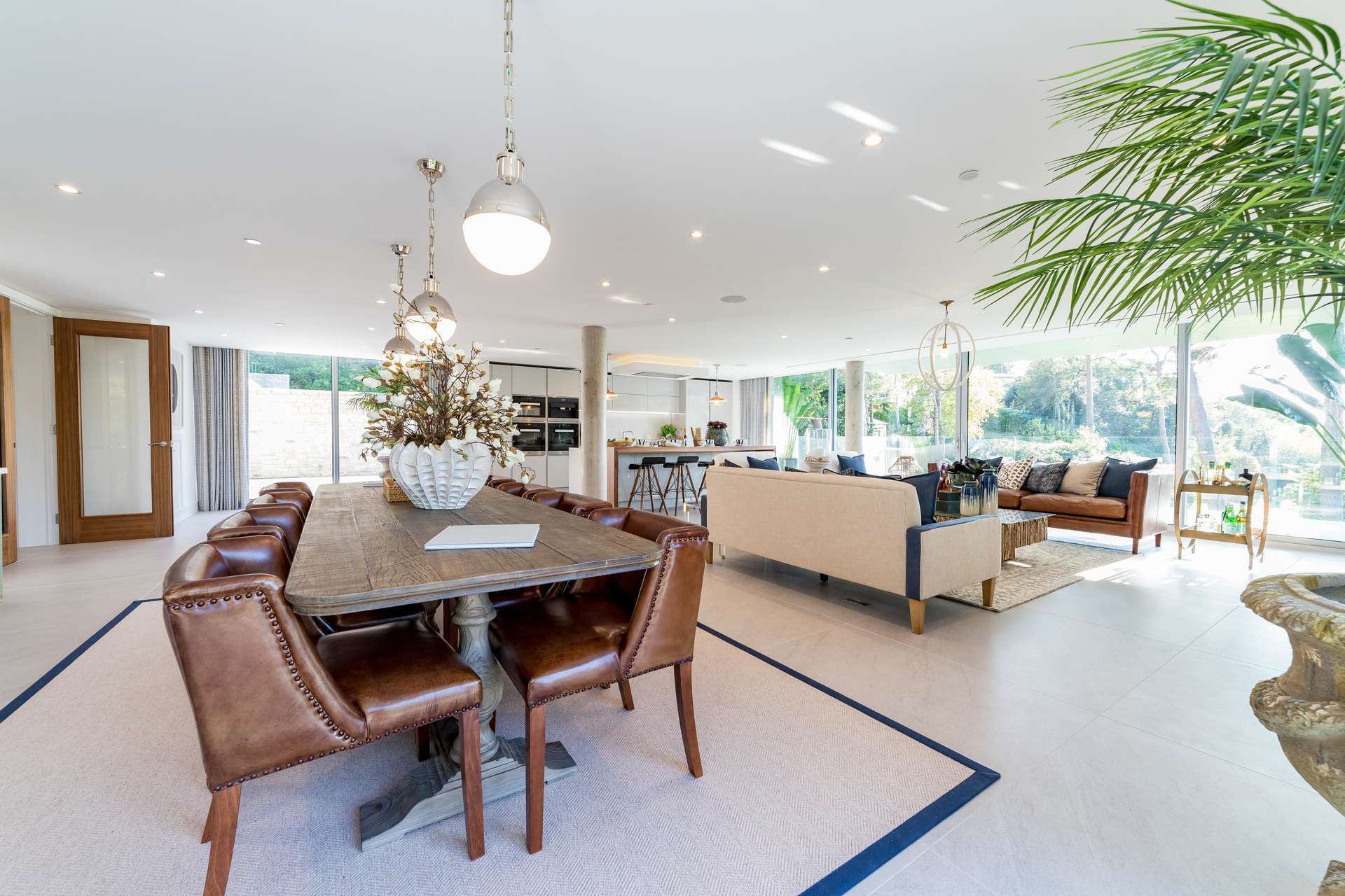 Open-plan living area in luxury Canford Cliffs villa, featuring elegant dining and seating spaces