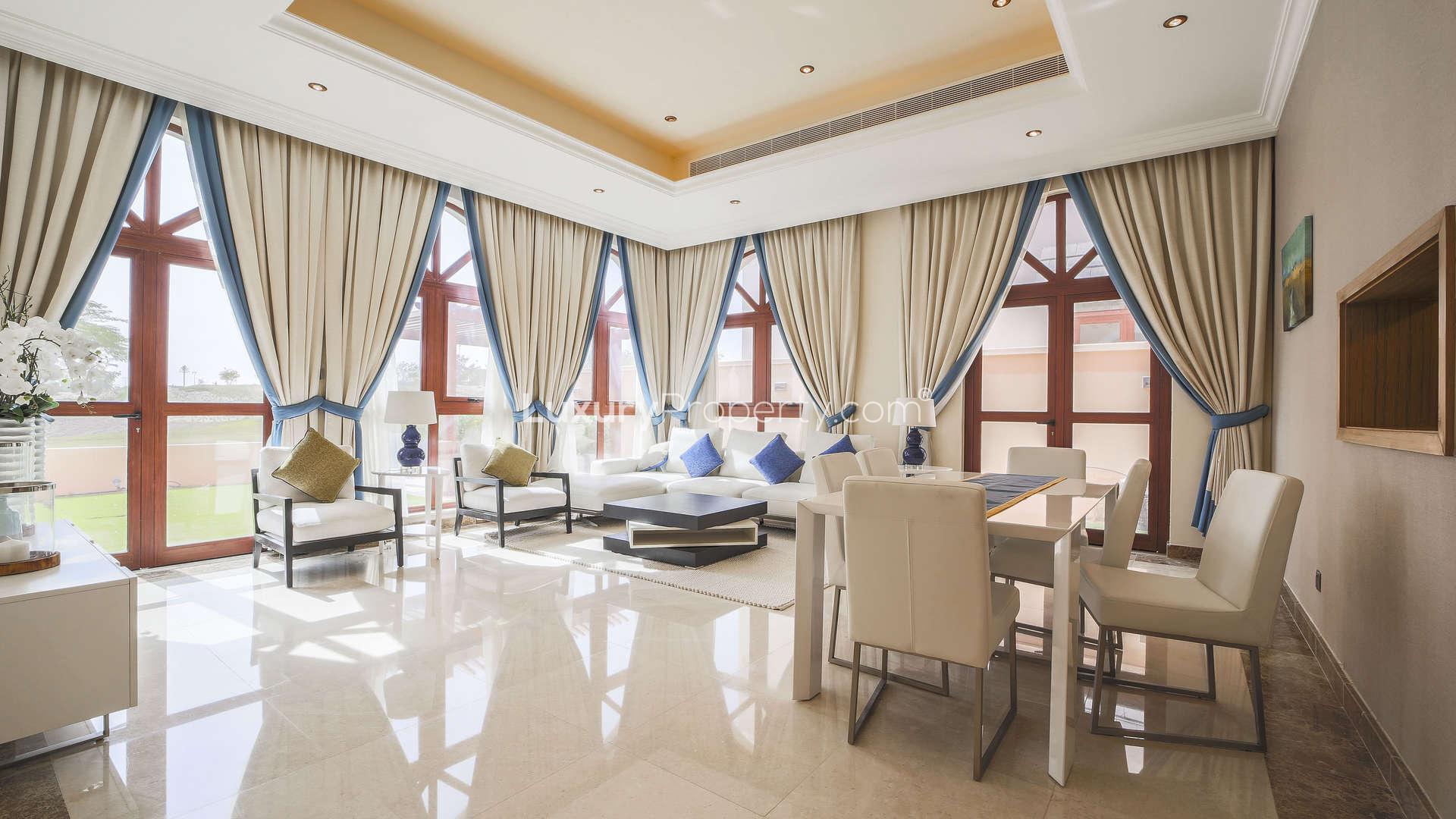 "Balcony view of lush landscape from 4-bedroom villa in Jumeirah Golf Estates, Orange Lake.",Luxurious living room in 4-bedroom villa, Orange Lake, Jumeirah Golf Estates, elegant decor