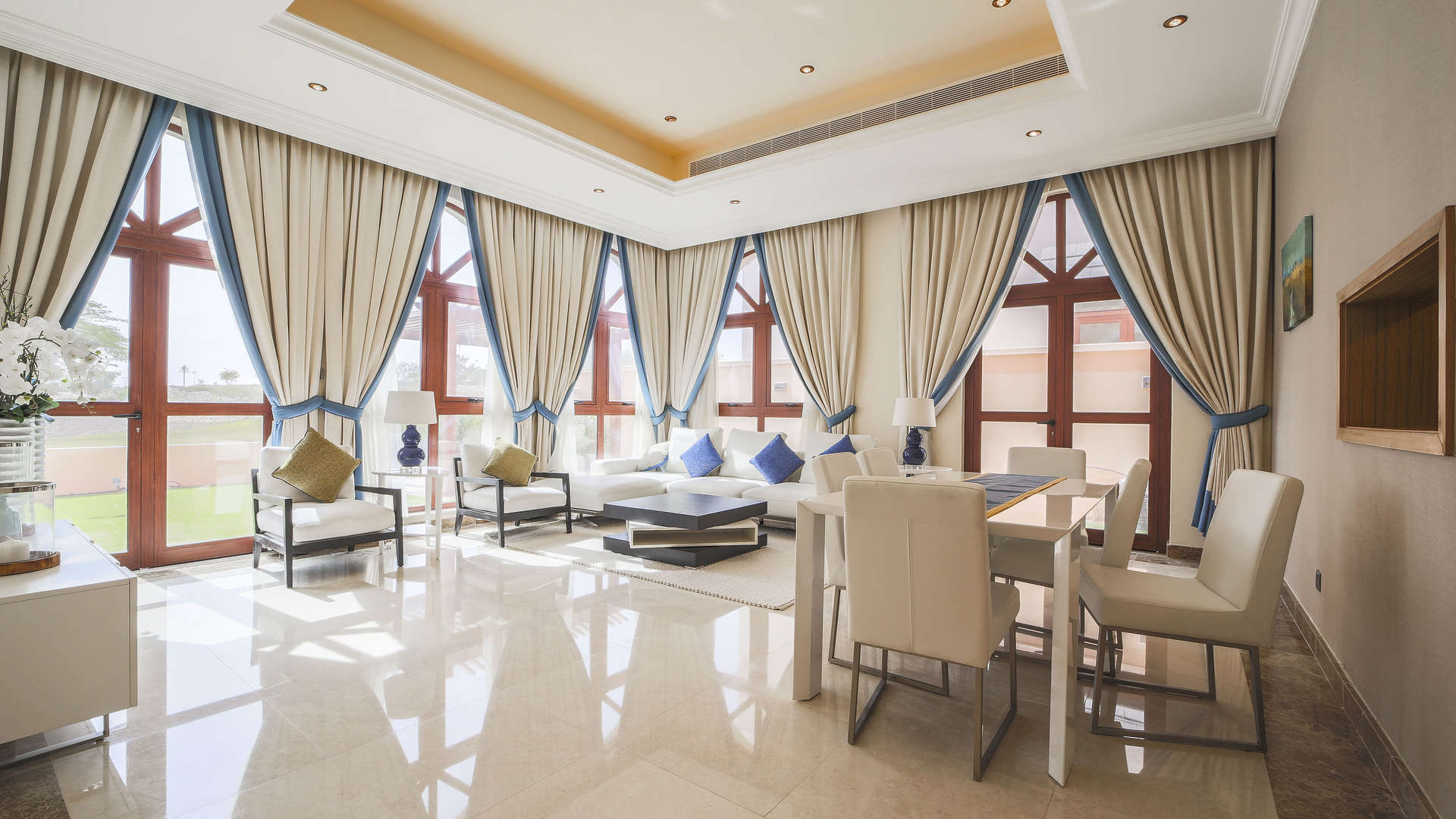 "Balcony view of lush landscape from 4-bedroom villa in Jumeirah Golf Estates, Orange Lake.",Luxurious living room in 4-bedroom villa, Orange Lake, Jumeirah Golf Estates, elegant decor