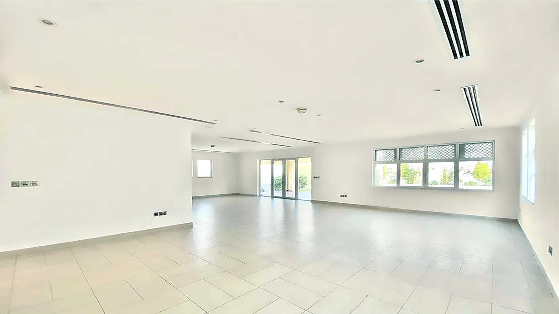 Spacious living area in Jumeirah Park villa with staircase and open kitchen layout