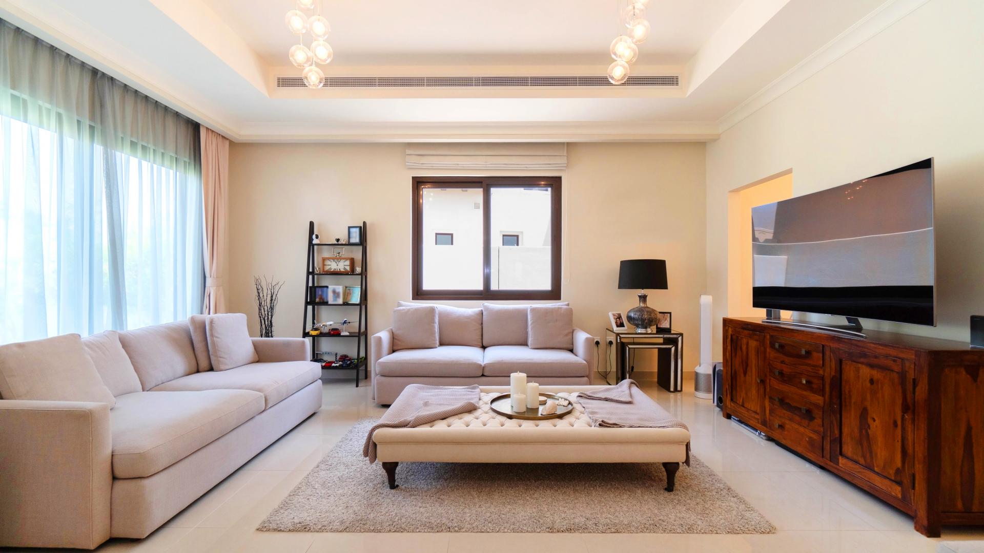 Alt text: "Scenic balcony view from 4-bedroom villa in Rosa, Arabian Ranches 2.",Living room in spacious 4-bedroom villa, Rosa, Arabian Ranches 2, modern decor, large windows