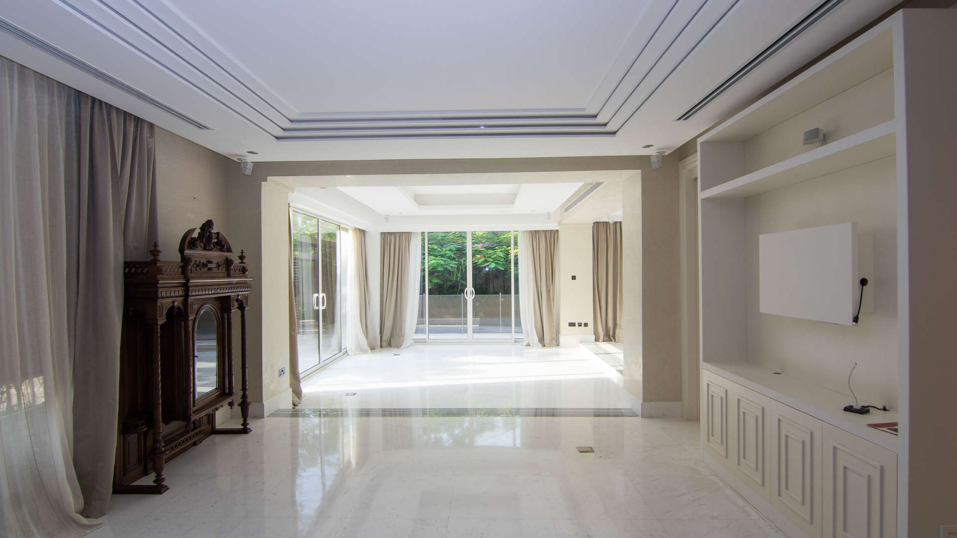 Luxurious living room in Saadiyat Beach villa with large windows and elegant decor