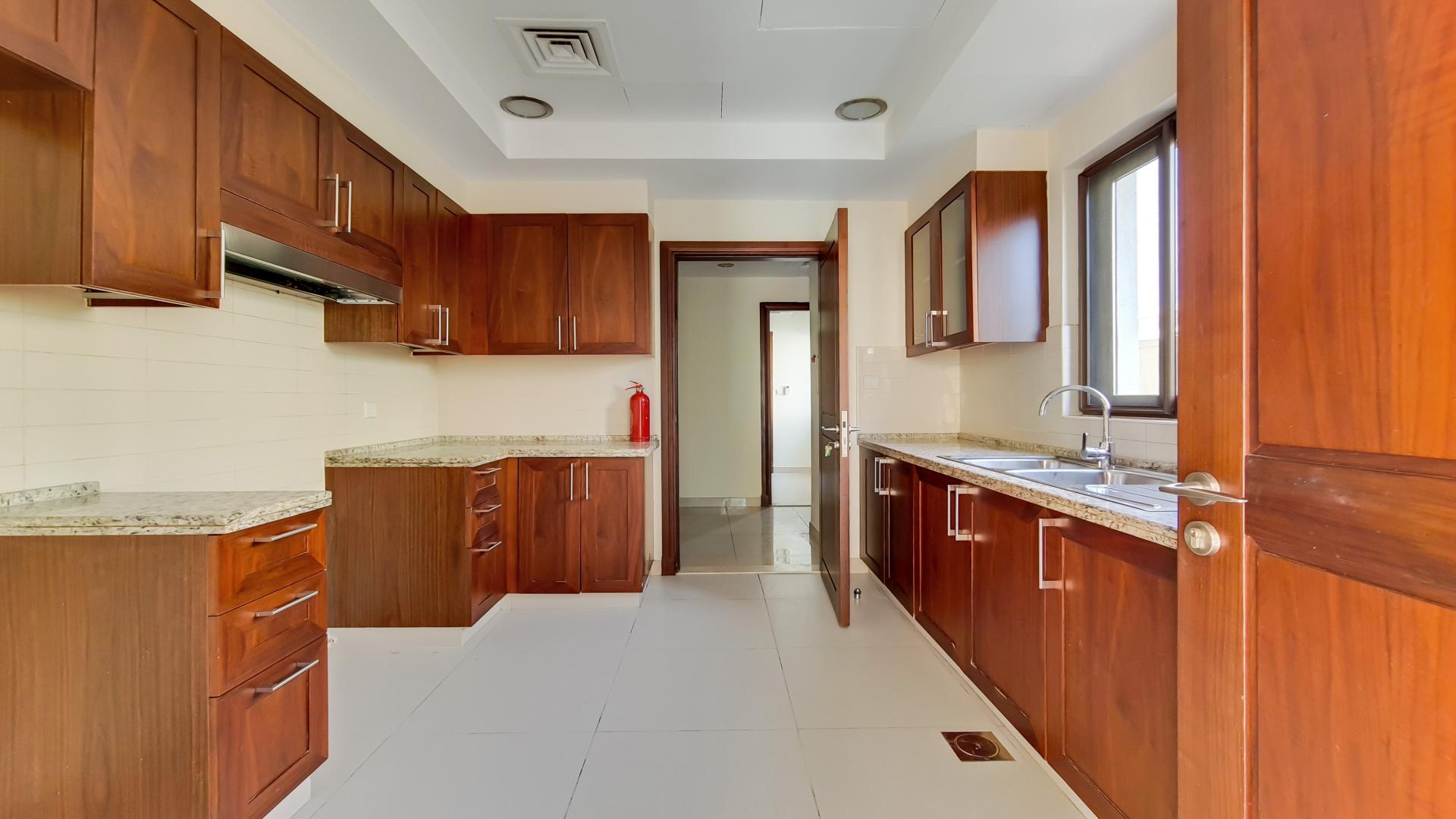 Kitchen with wooden cabinets in Samara villa, Arabian Ranches 2, for sale