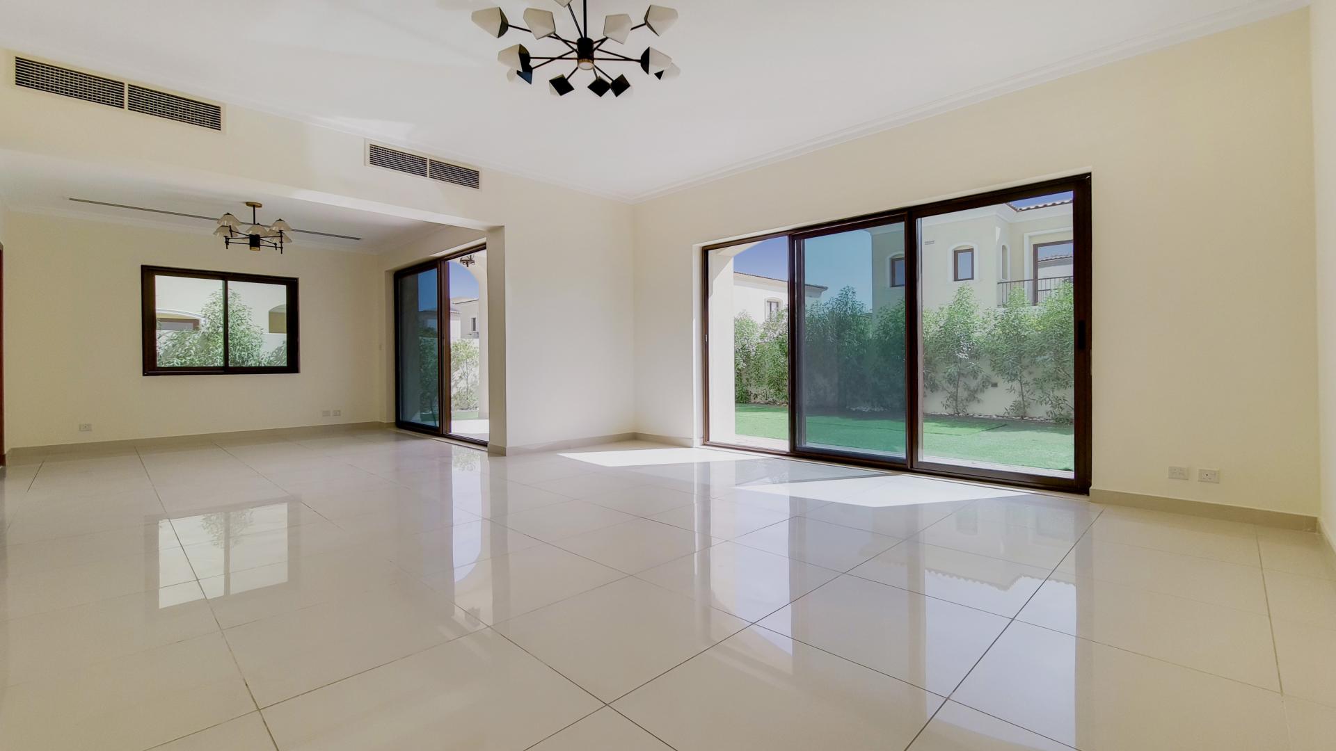 "Stunning villa with landscaped garden in Samara, Arabian Ranches 2, for sale.",Spacious living room with large windows in Samara villa, Arabian Ranches 2 for sale