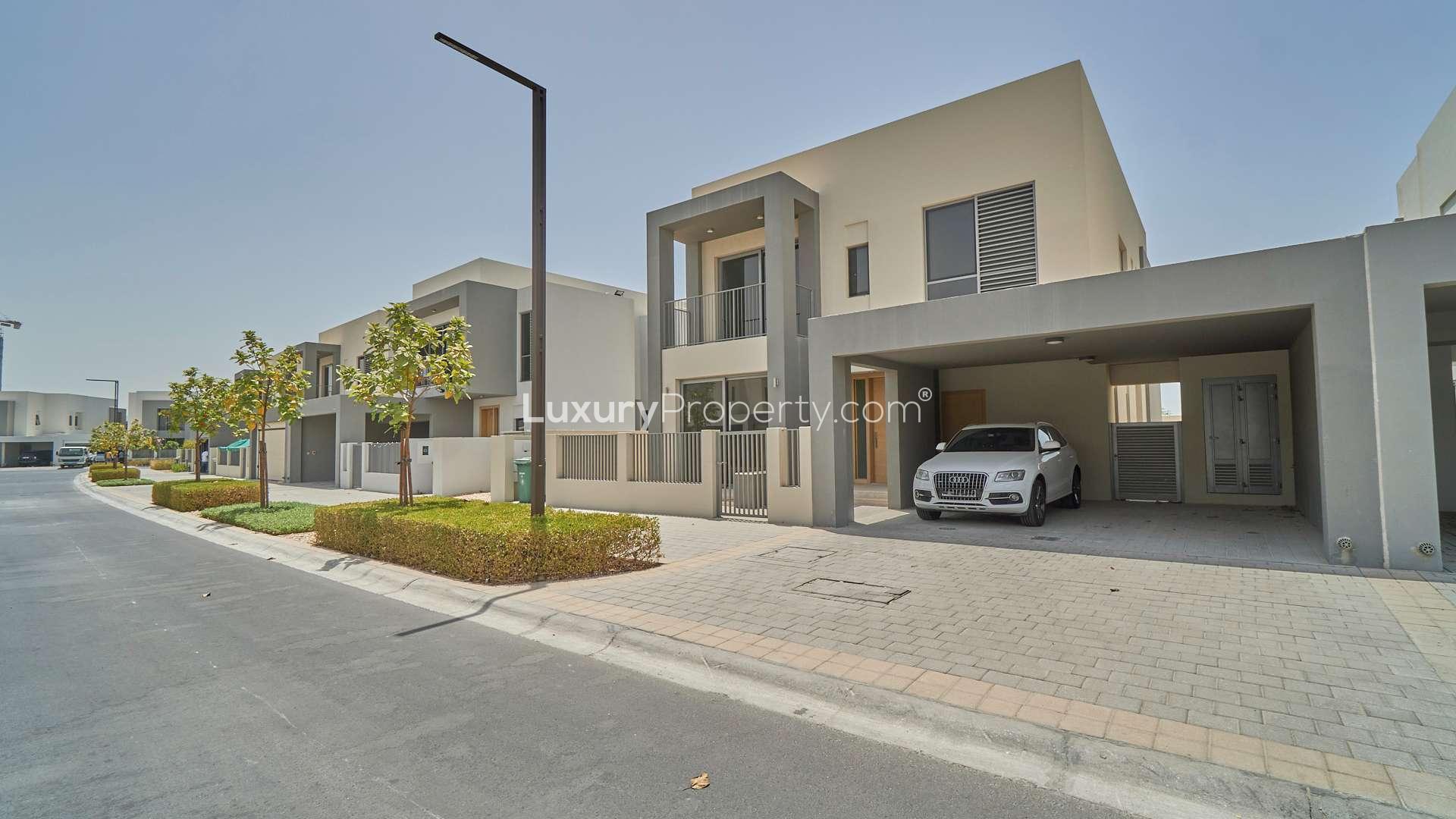 Single row 4-bedroom villa exterior in Sidra, Dubai Hills Estate, with driveway and car