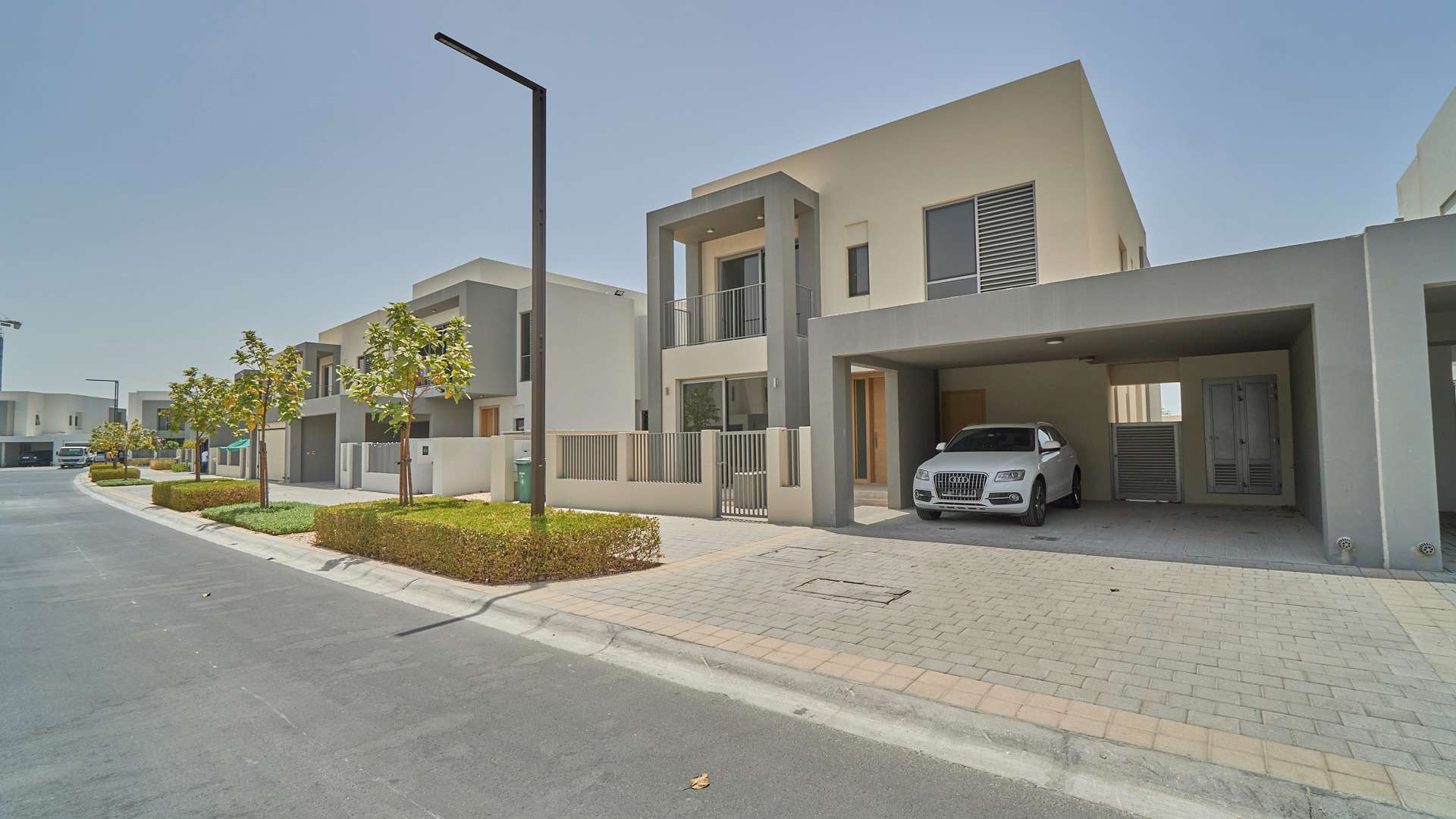 Single row 4-bedroom villa exterior in Sidra, Dubai Hills Estate, with driveway and car