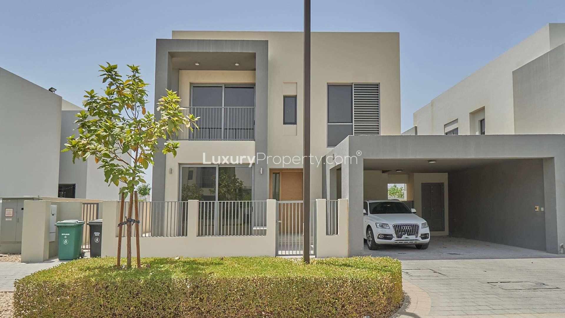 Modern 4-bedroom villa exterior in Sidra, Dubai Hills Estate, with carport and garden