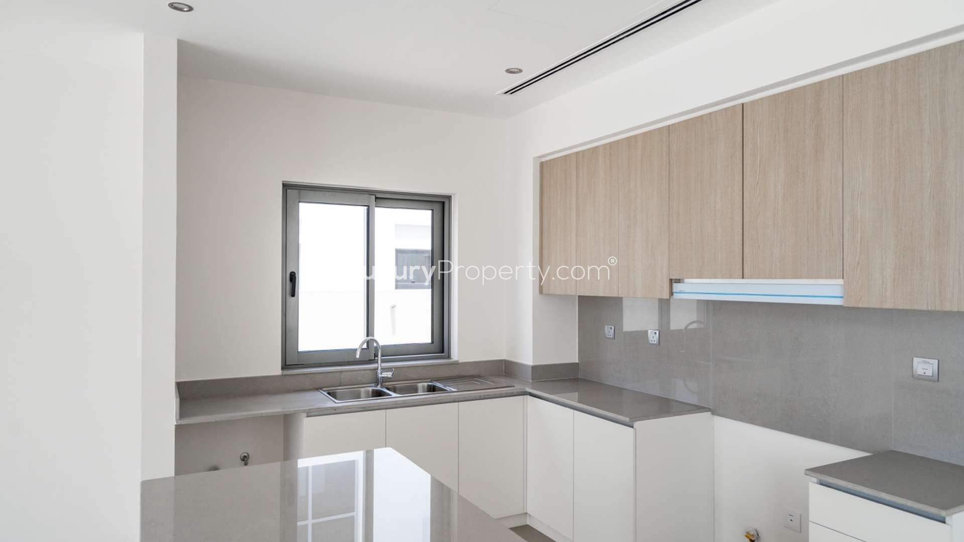 Modern 4-bedroom villa exterior in Sidra 1, Dubai Hills Estate, with lush green lawn