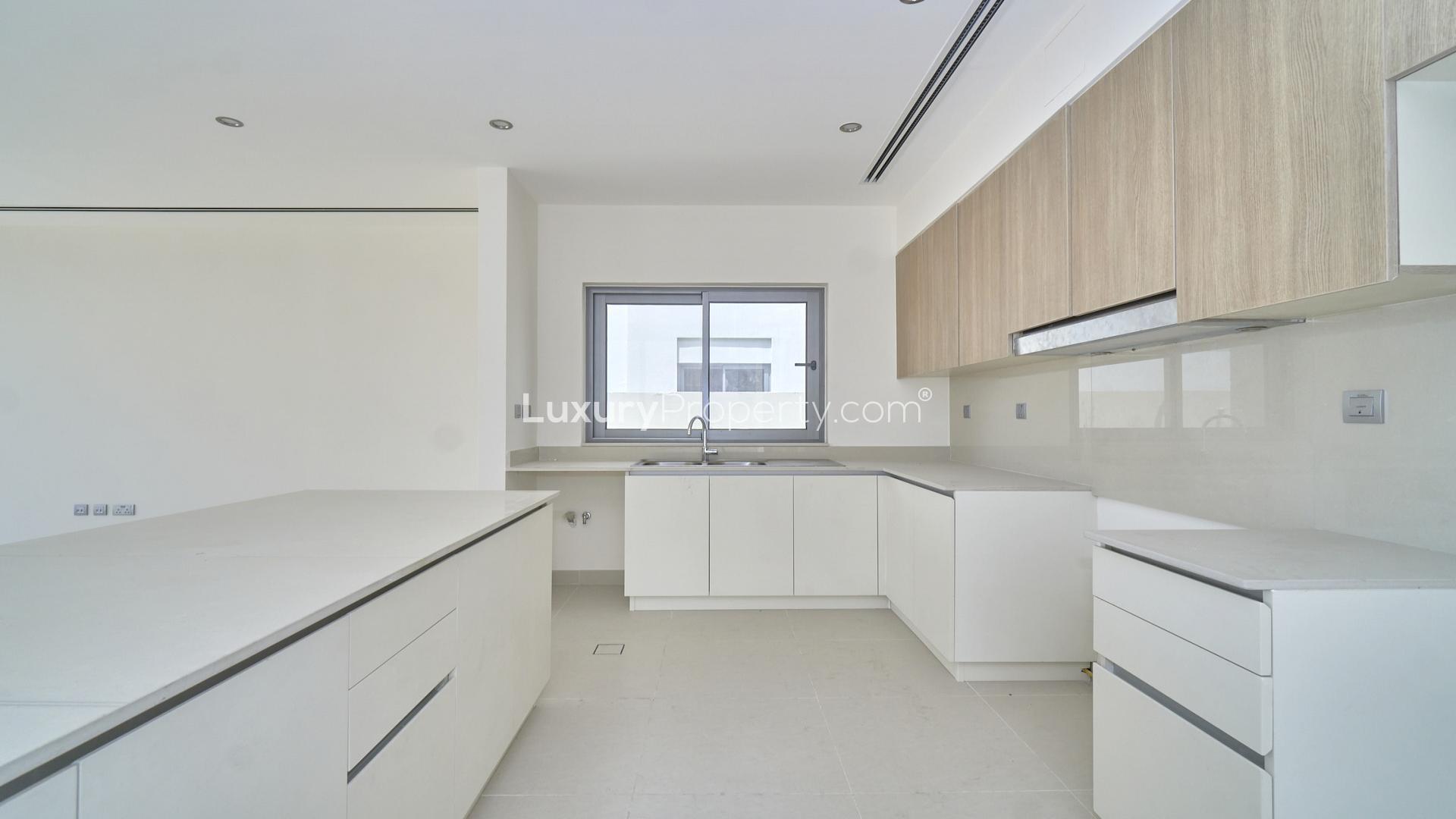 Contemporary open-plan kitchen and living area in Dubai Hills Estate villa, Sidra Villas