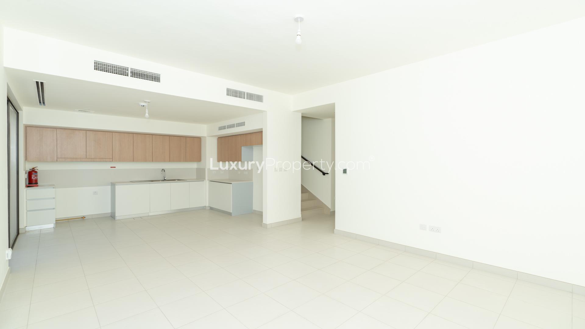 Modern kitchen with sliding glass door in 4-bedroom villa, Parkside 2, Emaar South