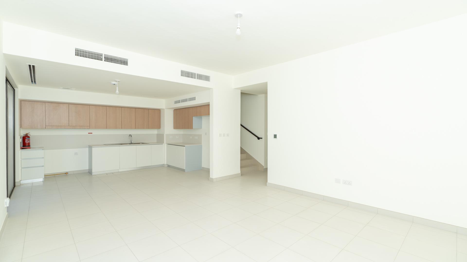 Modern kitchen with sliding glass door in 4-bedroom villa, Parkside 2, Emaar South