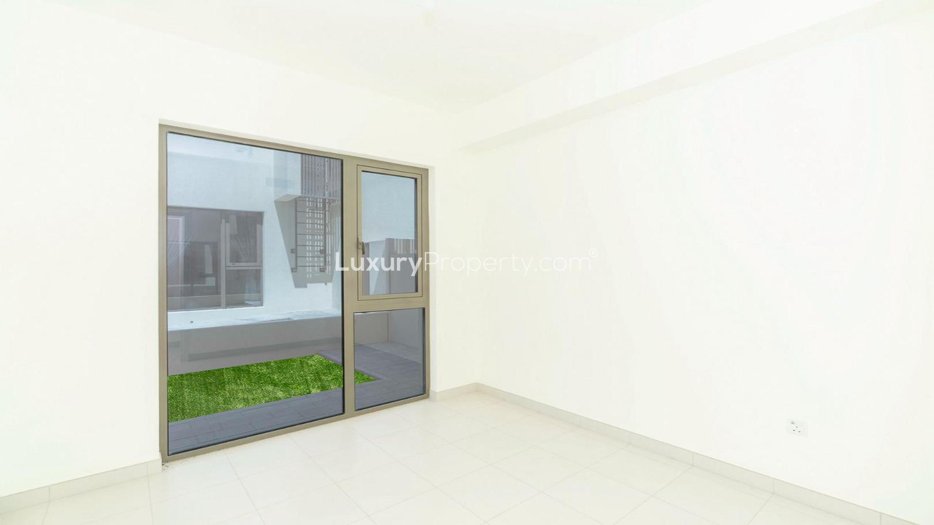 "Spacious living area with large windows in 4-bedroom villa, Parkside 2, Emaar South.",Empty room with large window in 4-bedroom villa, Parkside 2, Emaar South