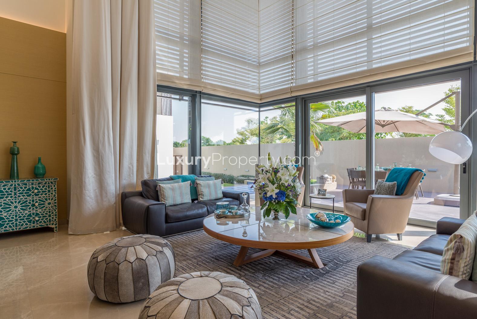 Contemporary dining area with pool view in Sobha Hartland villa for sale