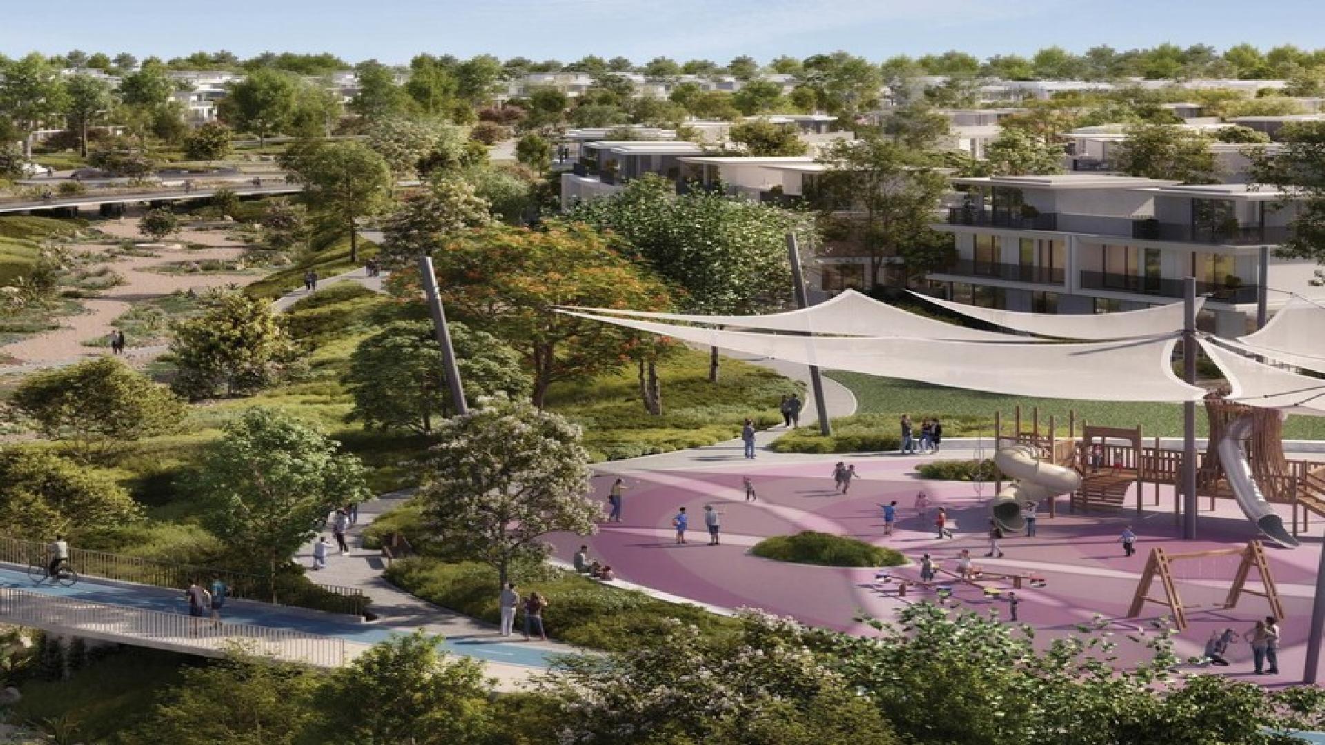 Outdoor play area at Avena, The Valley Phase 2, with families enjoying nature-inspired living