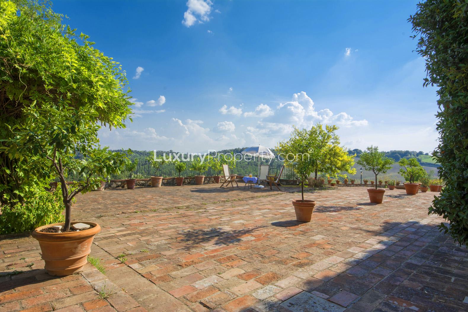 Stone villa courtyard with lush greenery in Siena, Tuscany estate for sale