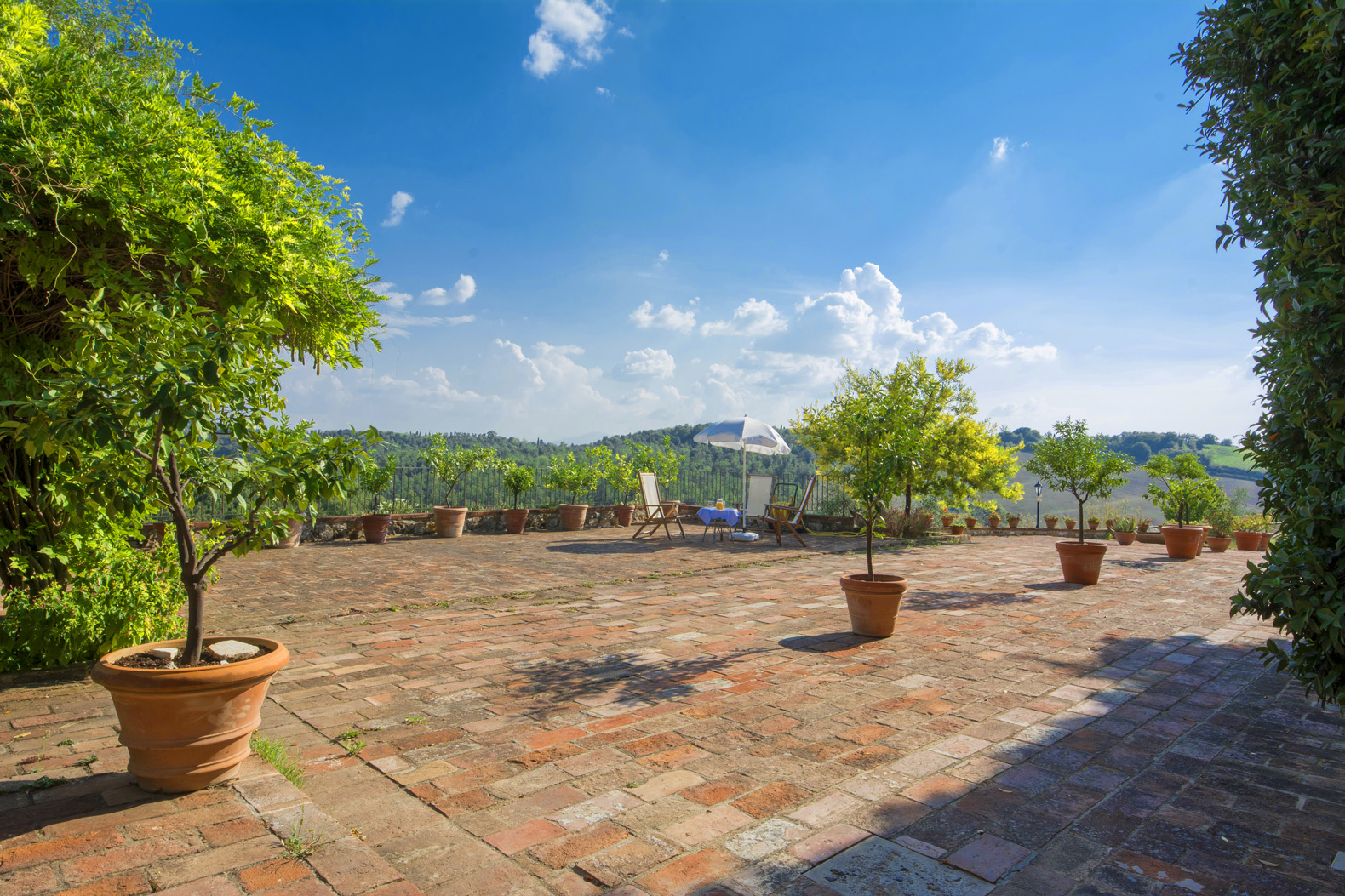 Stone villa courtyard with lush greenery in Siena, Tuscany estate for sale