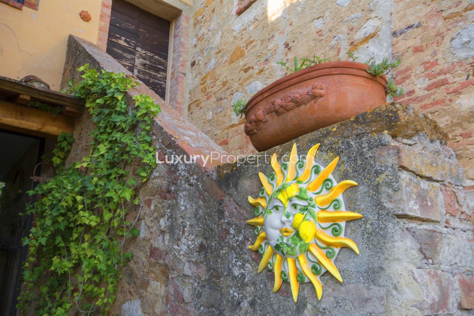 Sunny terrace with potted plants and scenic views at Siena villa, Tuscany