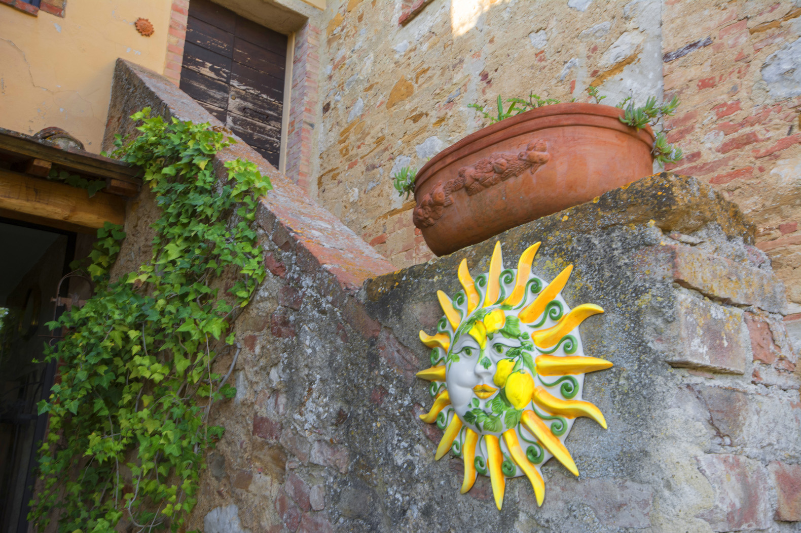 Sunny terrace with potted plants and scenic views at Siena villa, Tuscany