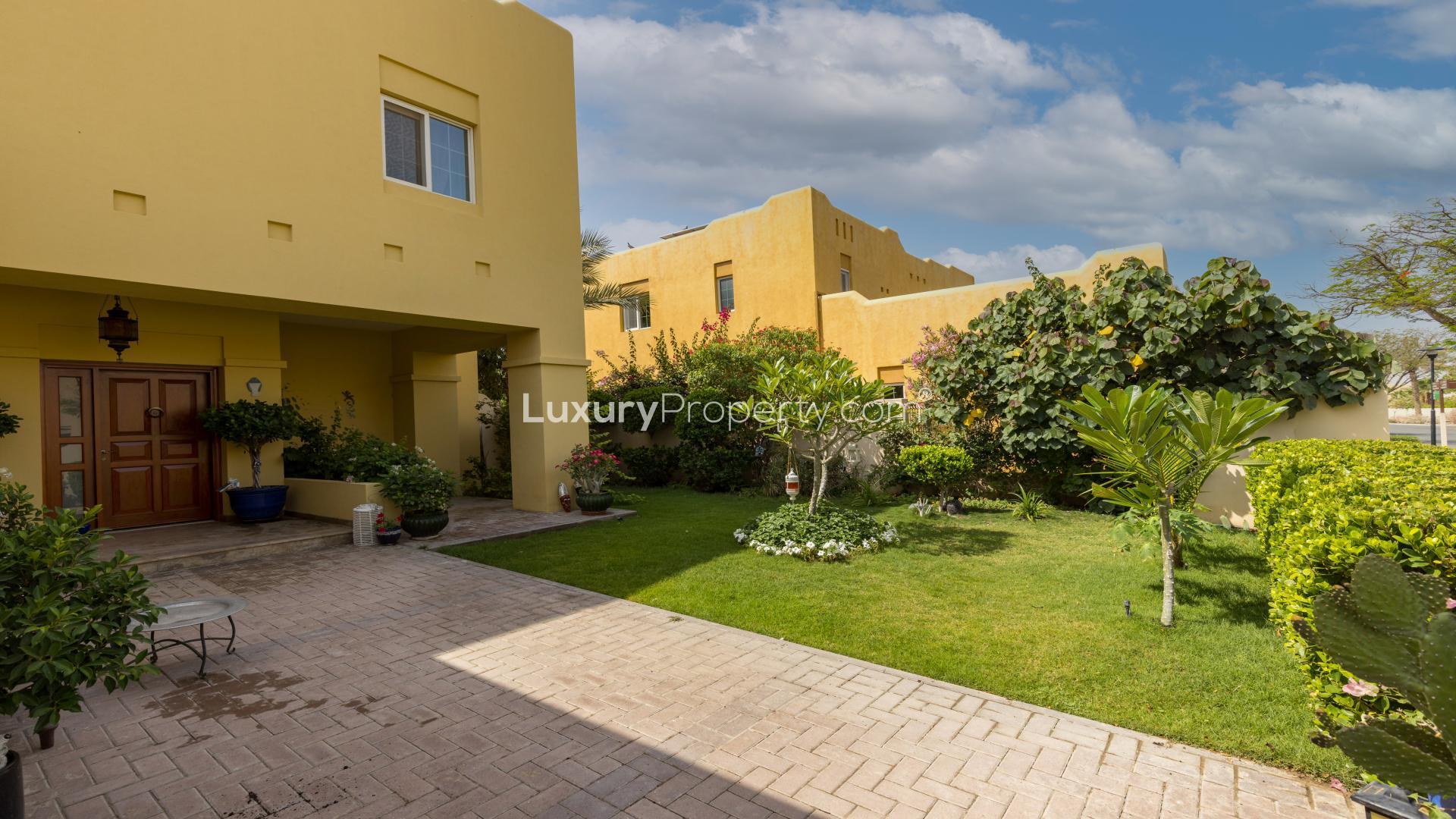 Spacious villa entrance with lush garden in Terra Nova, Arabian Ranches, for sale