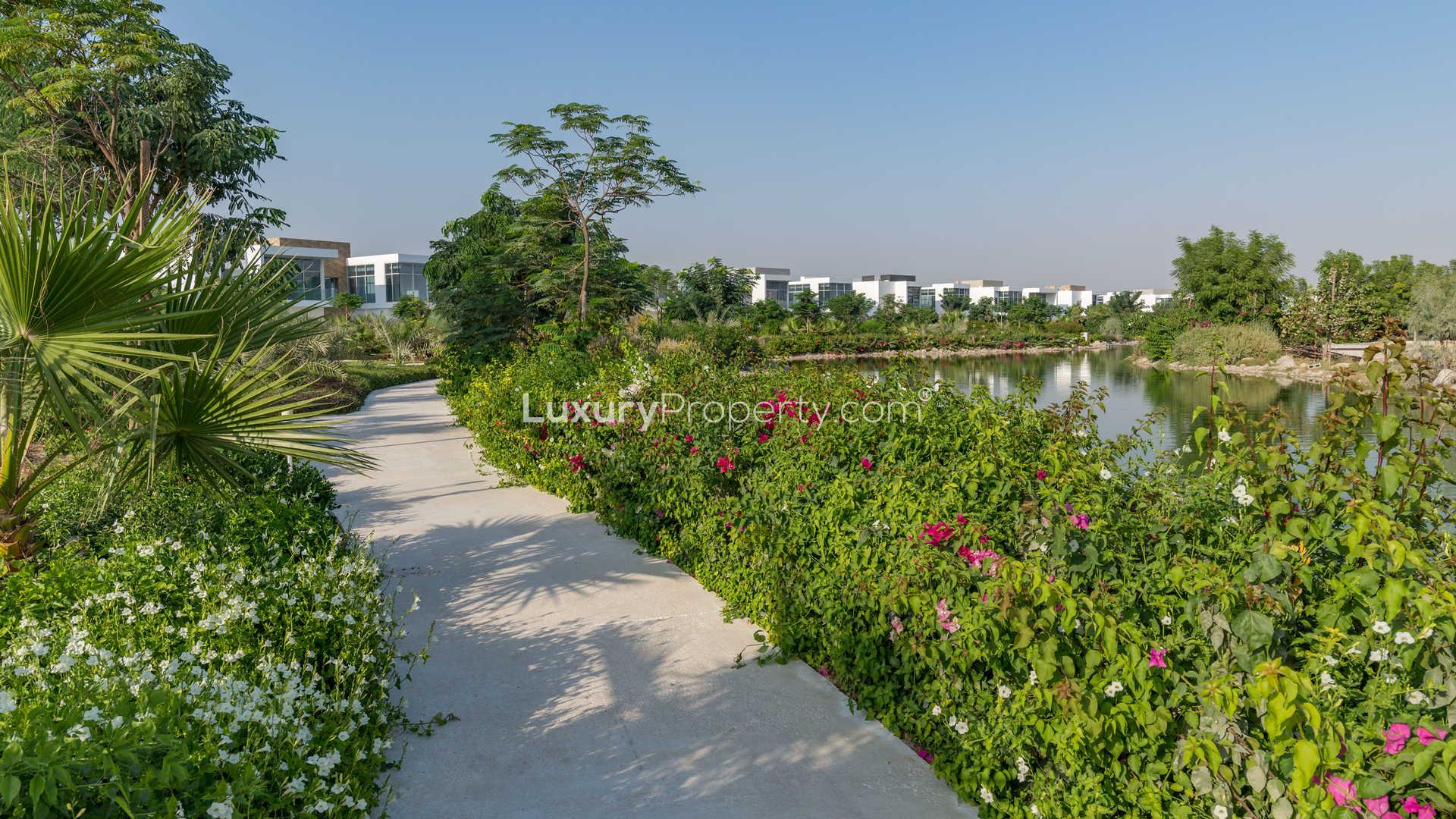 Scenic view of lush garden and pond at The Nest, Al Barari villa community