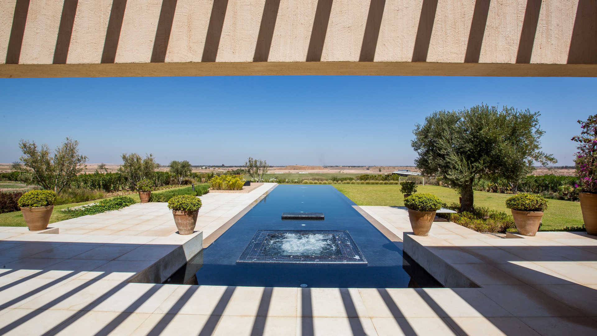 Bedroom with elegant decor and balcony view in Ritz-Carlton Marrakech villa for sale